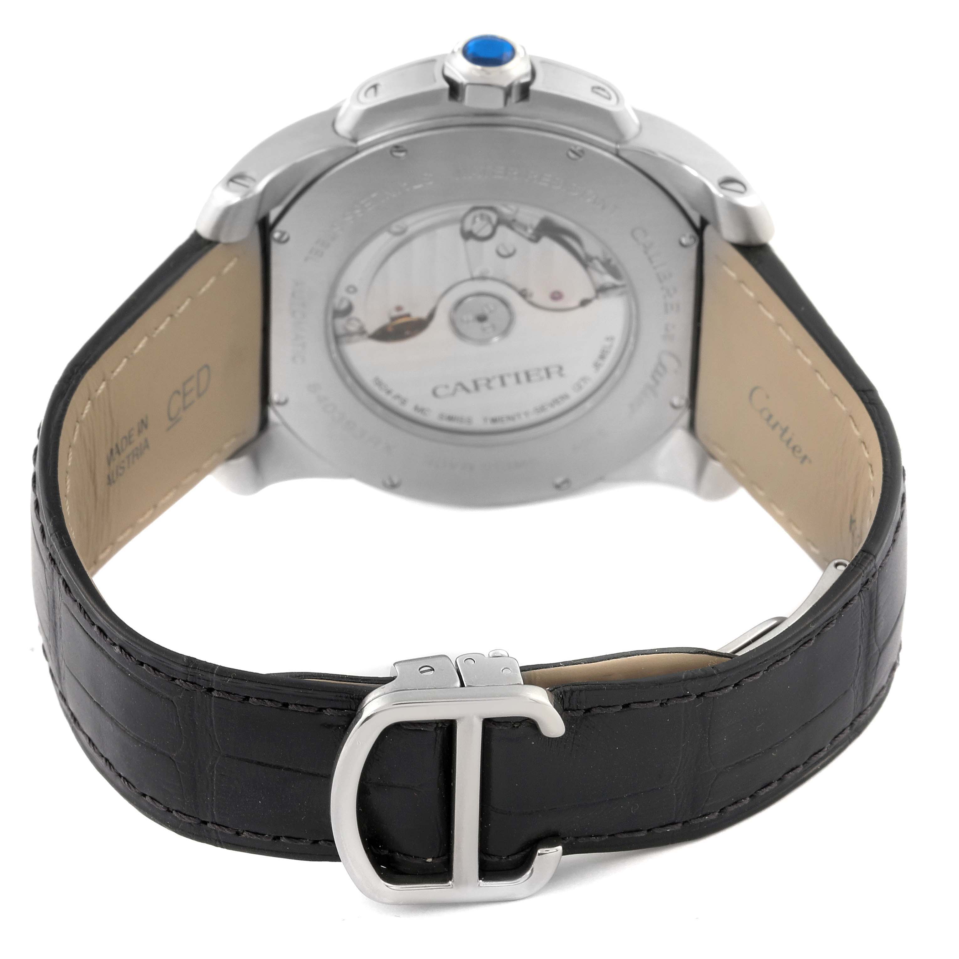 This image shows the back view of the Calibre de Cartier watch by Cartier, highlighting the movement and partial leather strap.