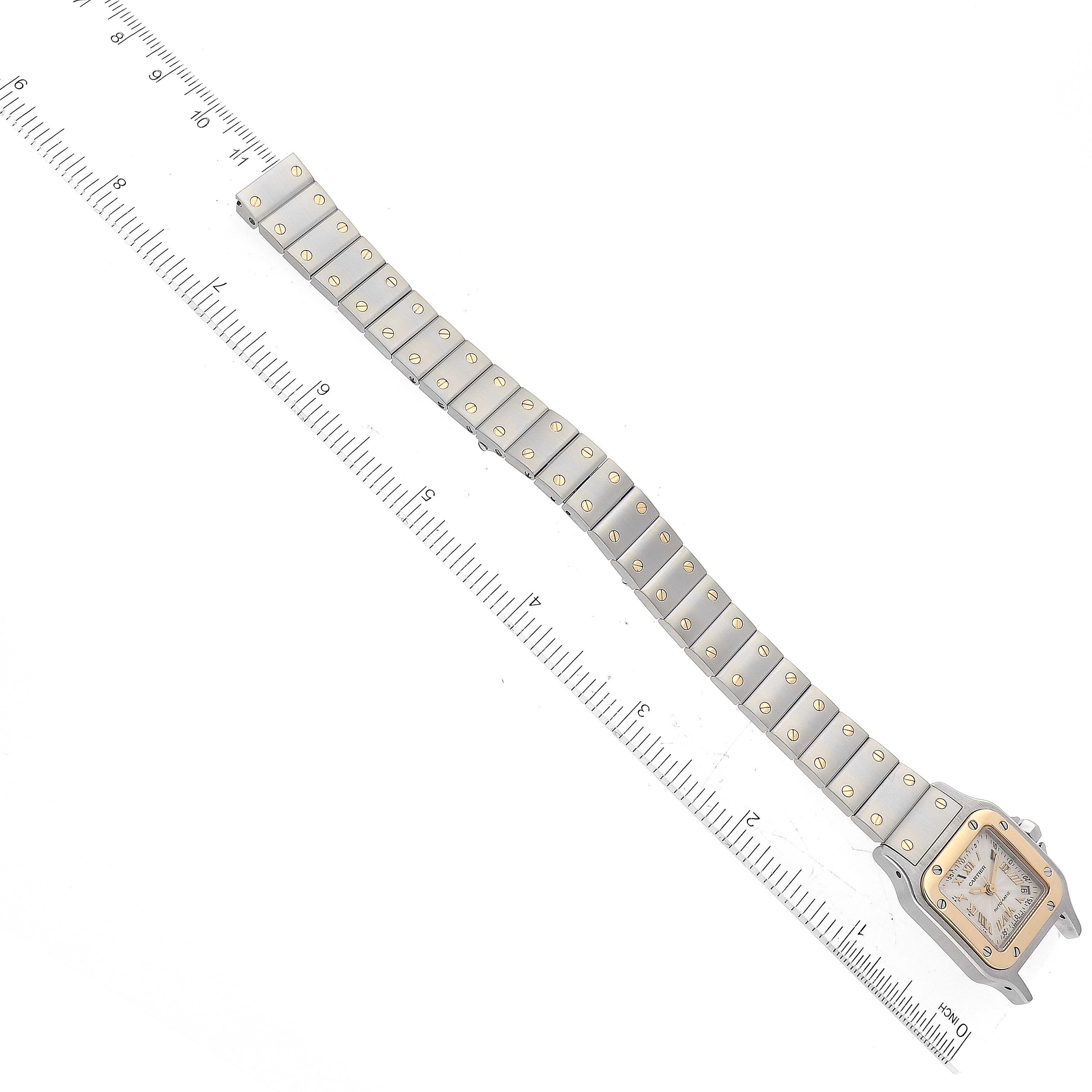 The image shows a Santos model watch by Cartier from a top-down angle, highlighting the bracelet and part of the square bezel.