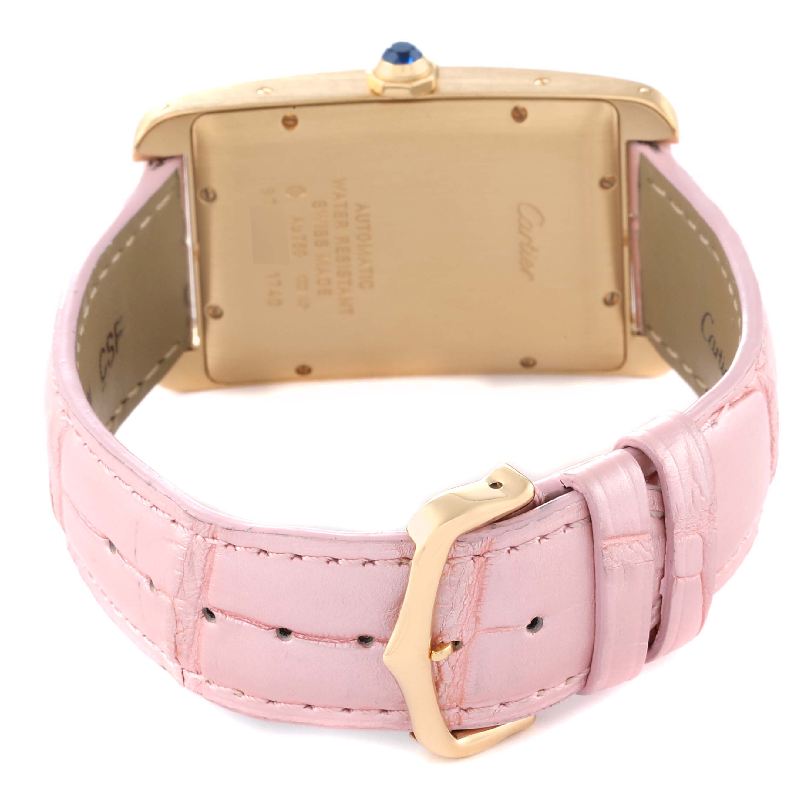 This image shows the back of the Cartier Tank Americaine W2603156 Men's Yellow Gold Silver Dial W2603156 Men's Yellow Gold Silver Dial watch and its pink leather strap with a gold buckle.