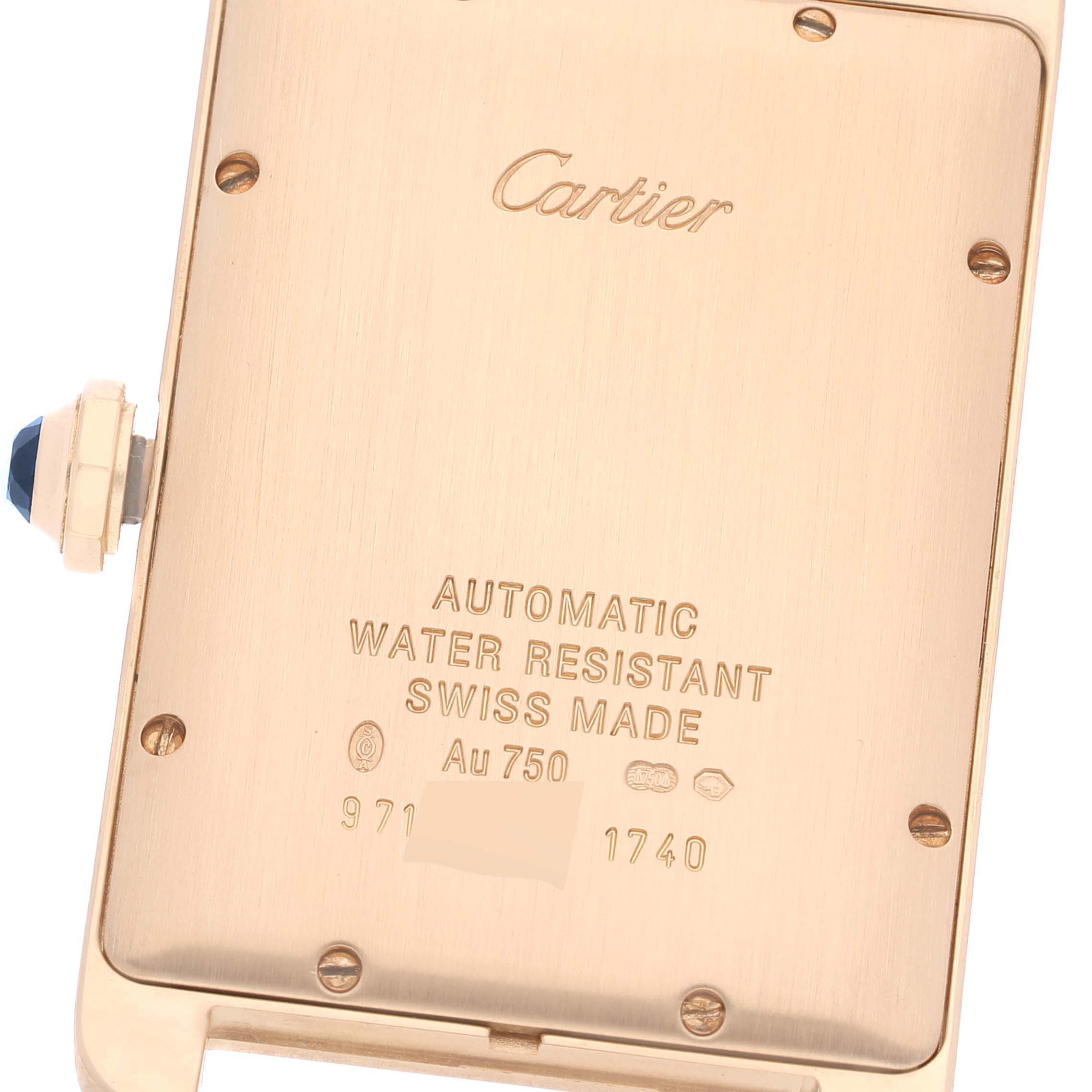 This image shows the back case of a Cartier Tank Americaine W2603156 Men's Yellow Gold Silver Dial W2603156 Men's Yellow Gold Silver Dial watch, including its crown and engraved details.