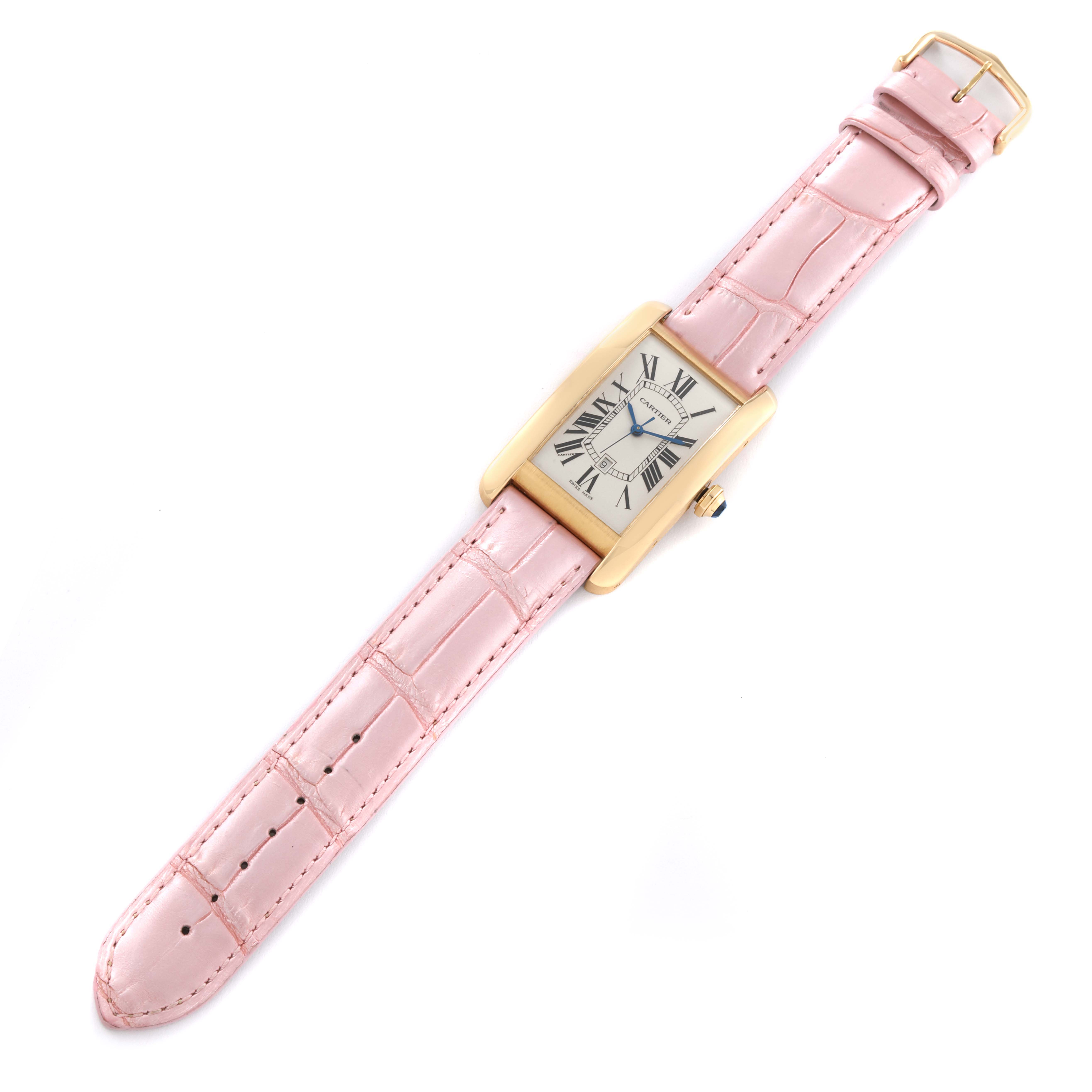 The image shows a Cartier Tank Américaine watch laid flat with a pink leather strap and gold case.