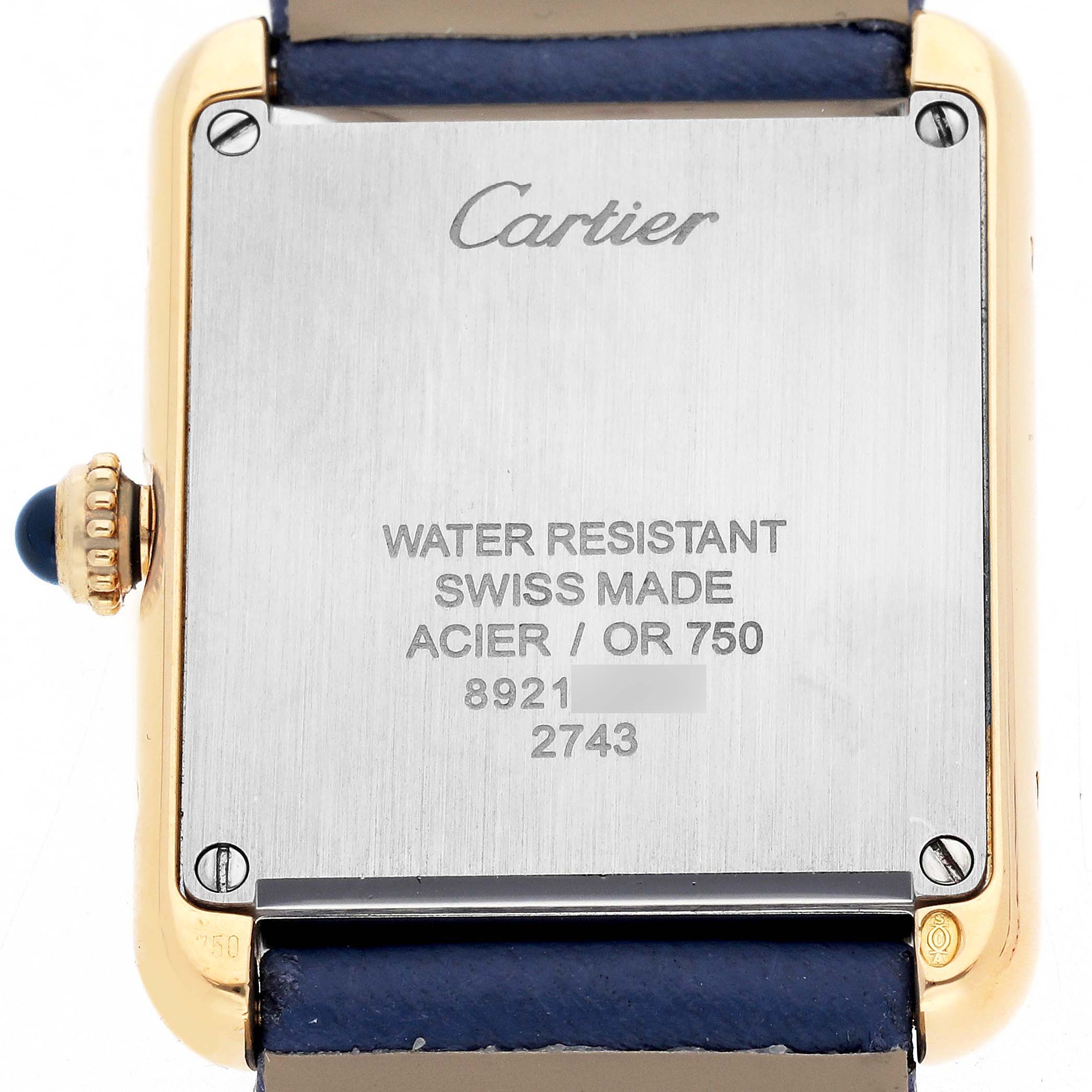 The image shows the back case of a Cartier Tank Solo W1018755 Women
s Yellow Gold Silver Dial watch, featuring brand engraving and specifications.