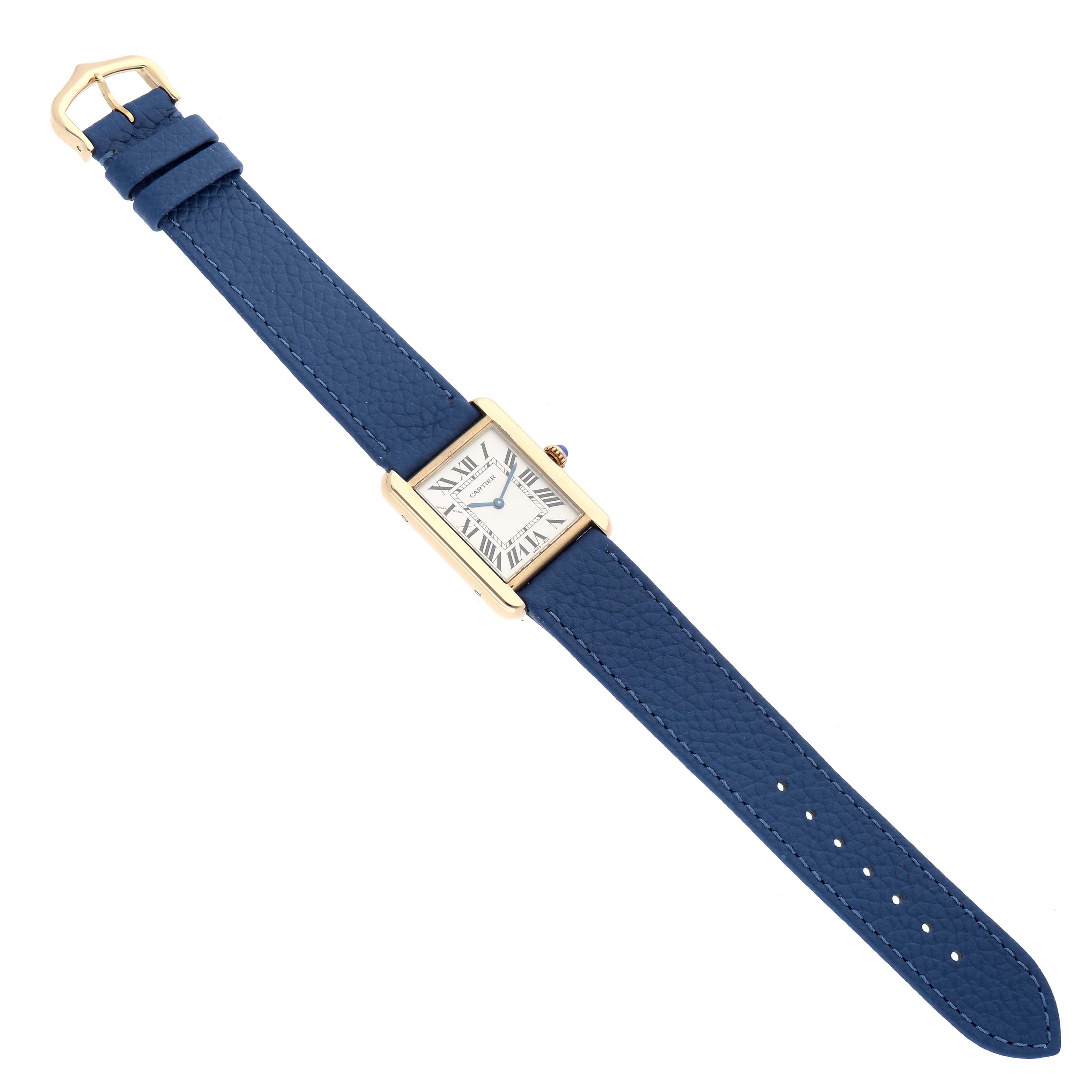 The Cartier Tank Solo W1018755 Women
s Yellow Gold Silver Dial watch is shown from a top-down angle, highlighting its rectangular face and blue leather strap.