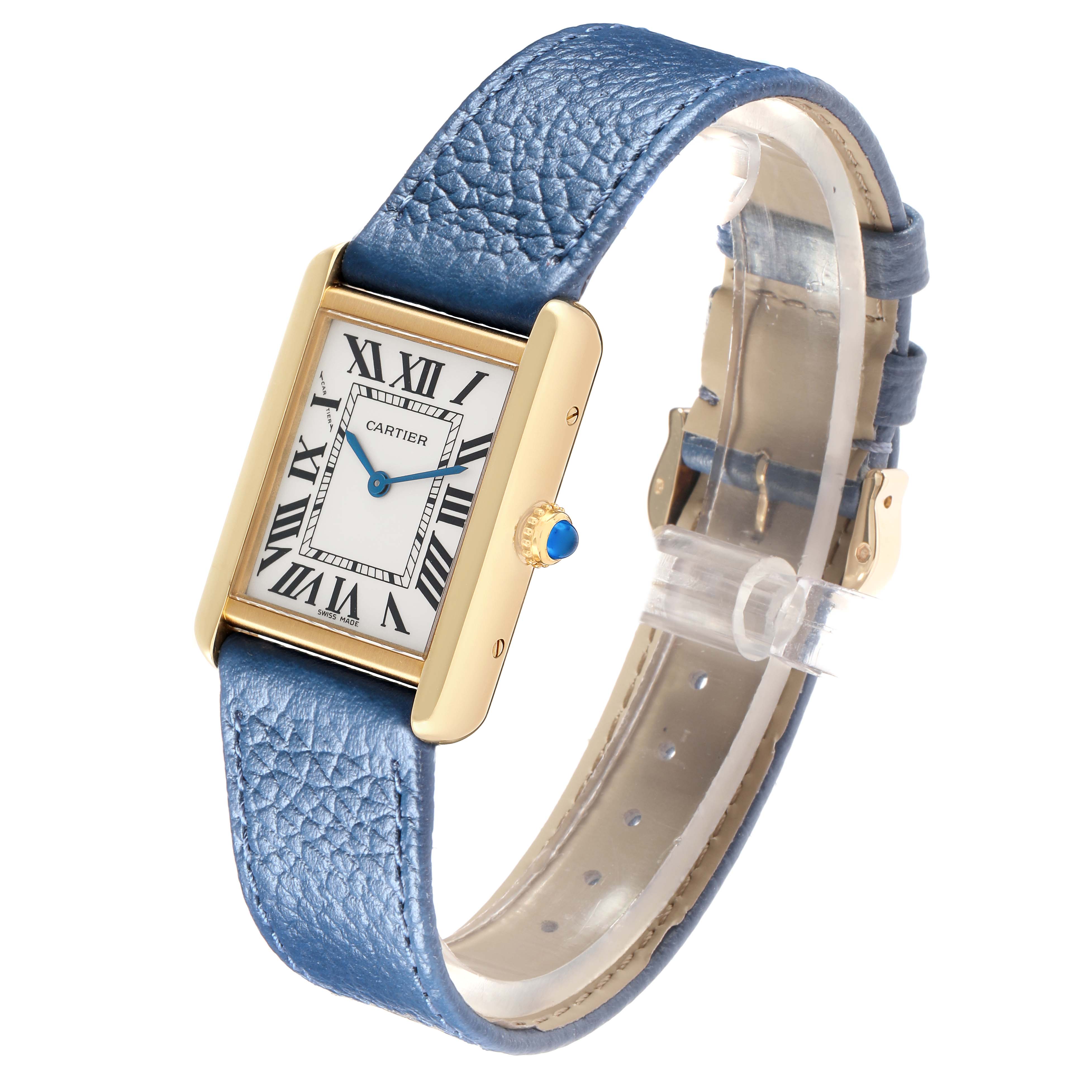 The Cartier Tank Solo W1018755 Women
s Yellow Gold Silver Dial watch is shown at a slight angle, displaying its face, blue leather strap, and gold case with the crown.
