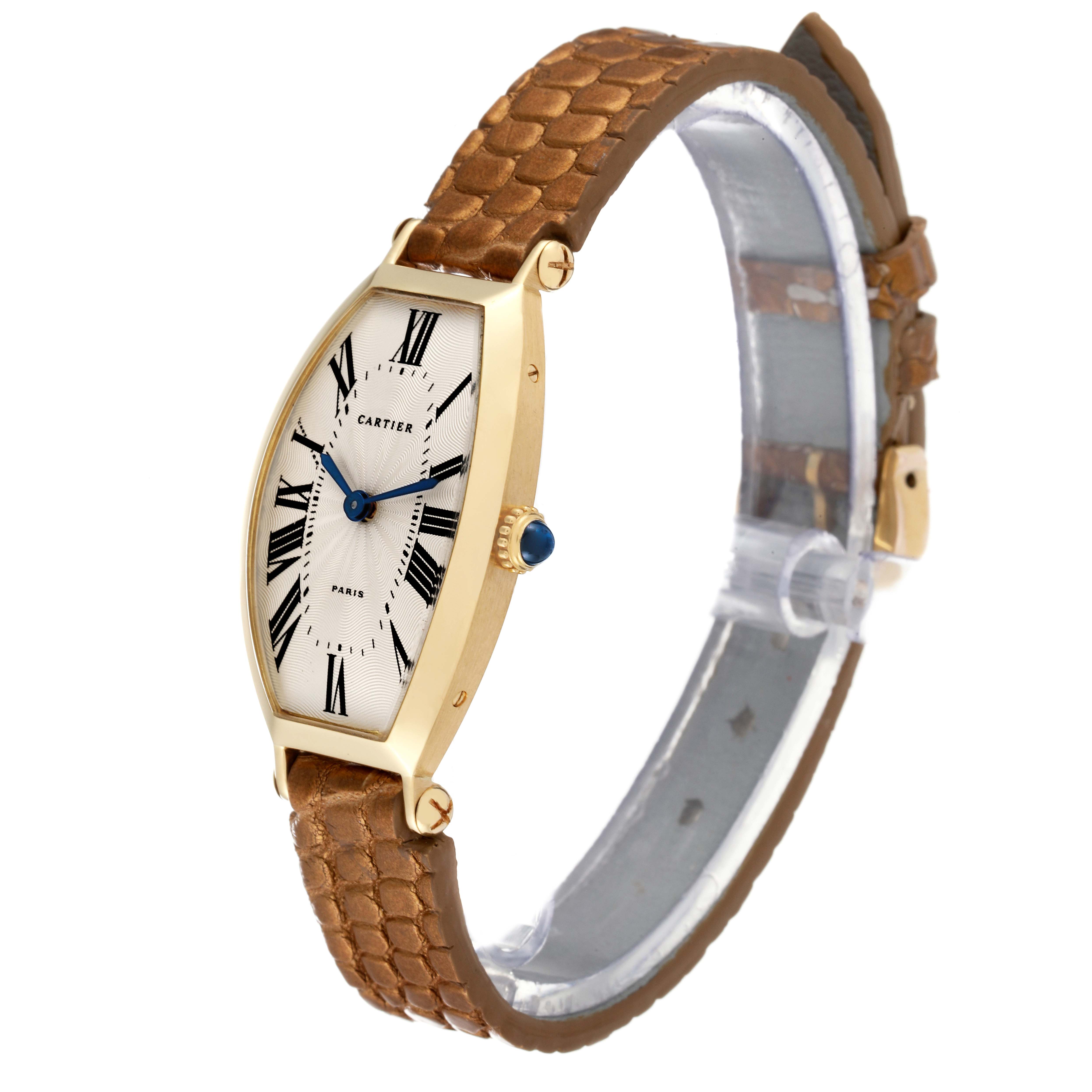 The image shows a side and frontal view of a Cartier Tonneau Women
s Yellow Gold Silver Dial Women
s Yellow Gold Silver Dial model watch with a brown leather strap.