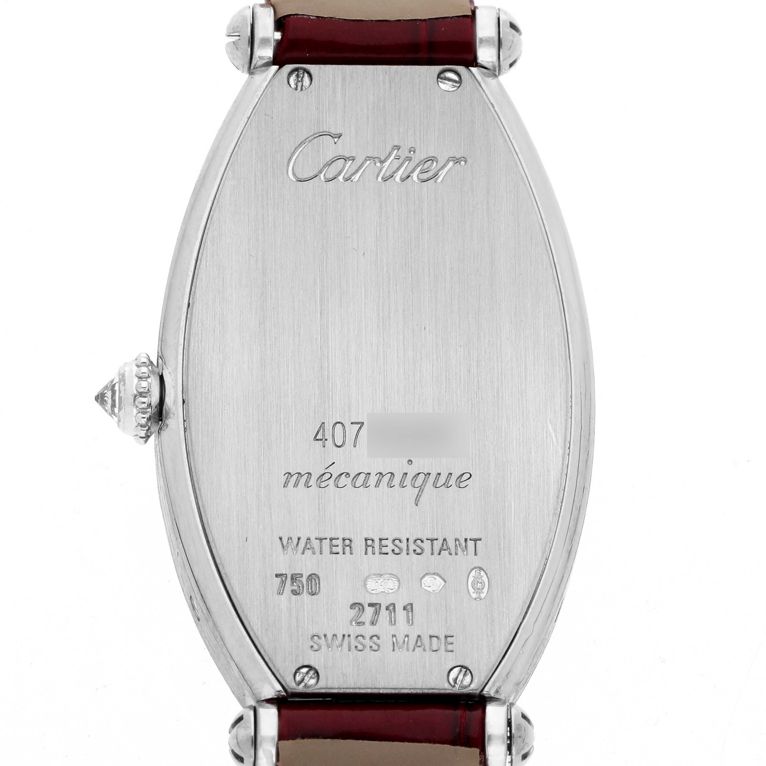 The image shows the back case of a Cartier Tonneau WE400131 Women
s White Gold Silver Dial watch, including the crown and engraved details.