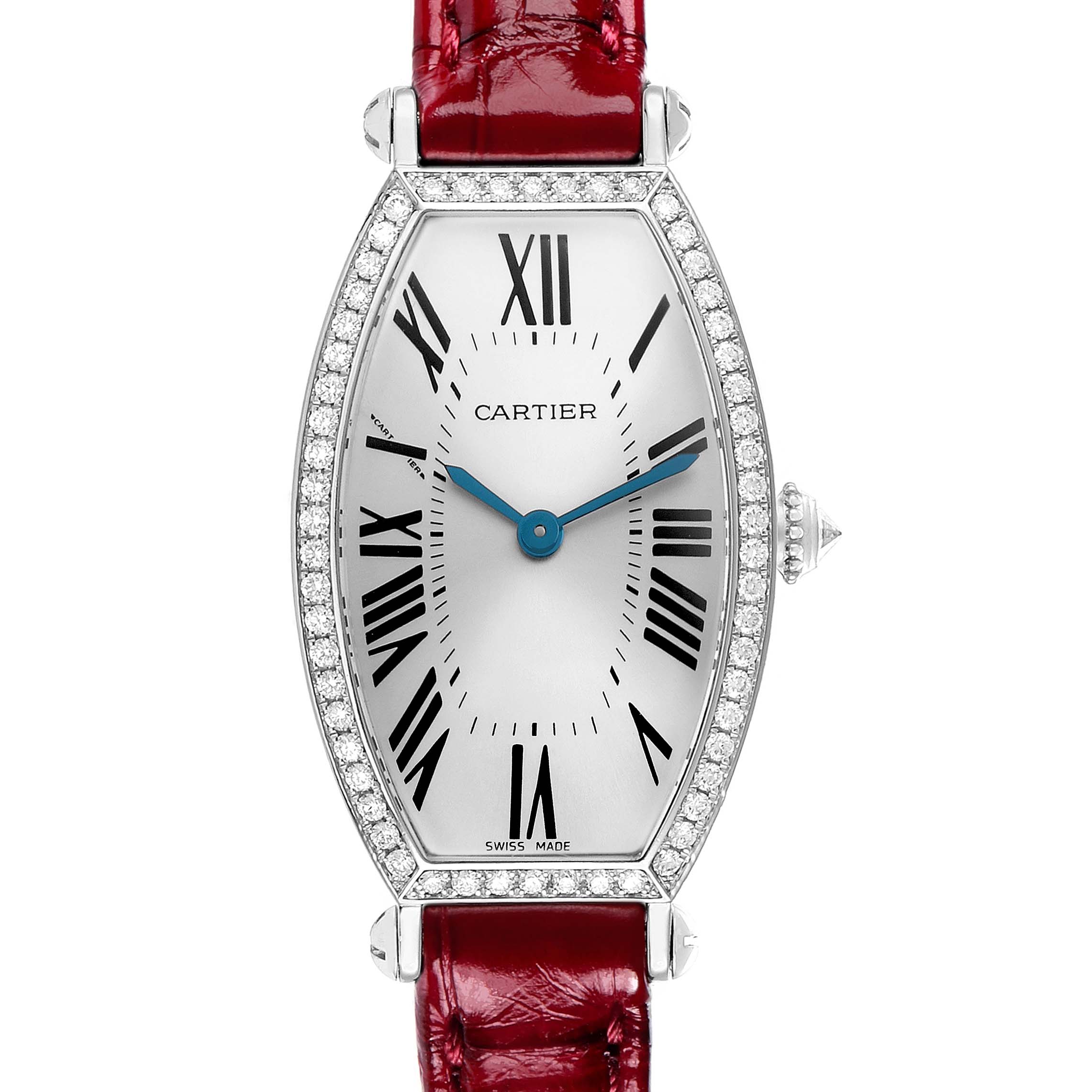 The Cartier Tonneau WE400131 Women
s White Gold Silver Dial watch is shown from a top view, displaying its face, bezel, blue hands, Roman numerals, and red strap.