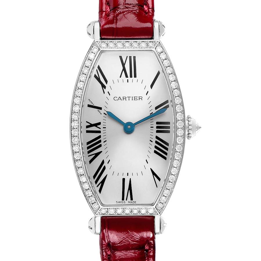 The Cartier Tonneau WE400131 Women's White Gold Silver Dial watch is shown from a top view, displaying its face, bezel, blue hands, Roman numerals, and red strap.