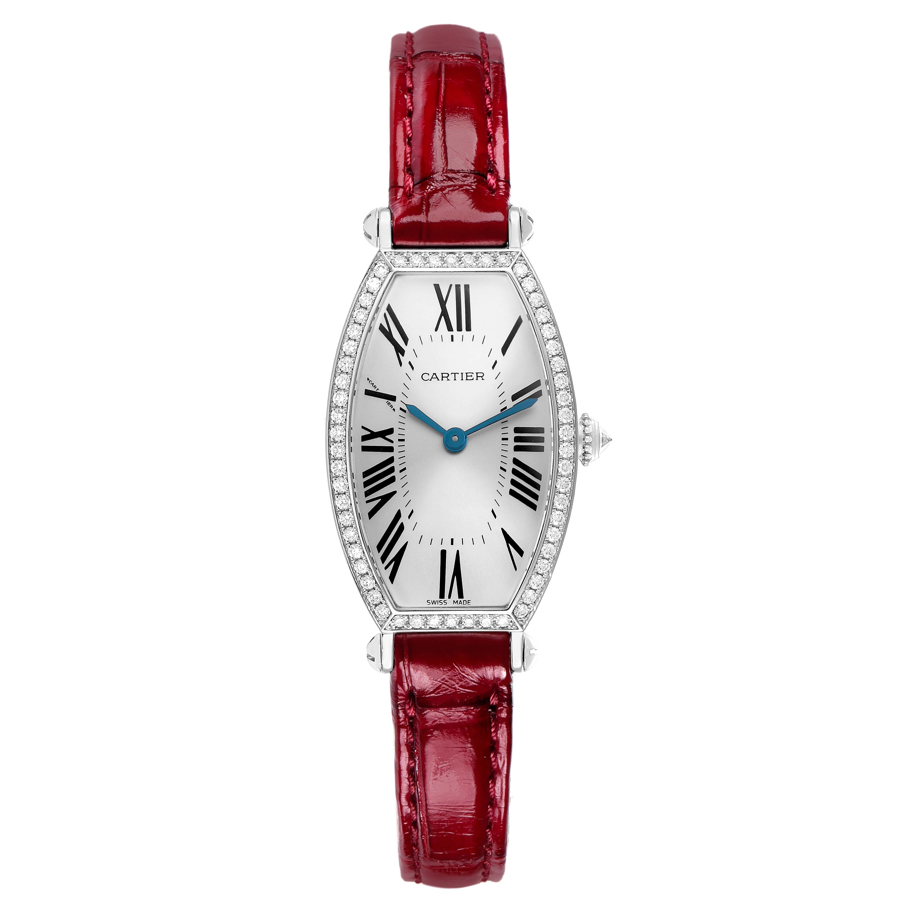 The Cartier Tonneau WE400131 Women
s White Gold Silver Dial watch is shown from the front, highlighting its elongated case, white dial, Roman numerals, and red strap.