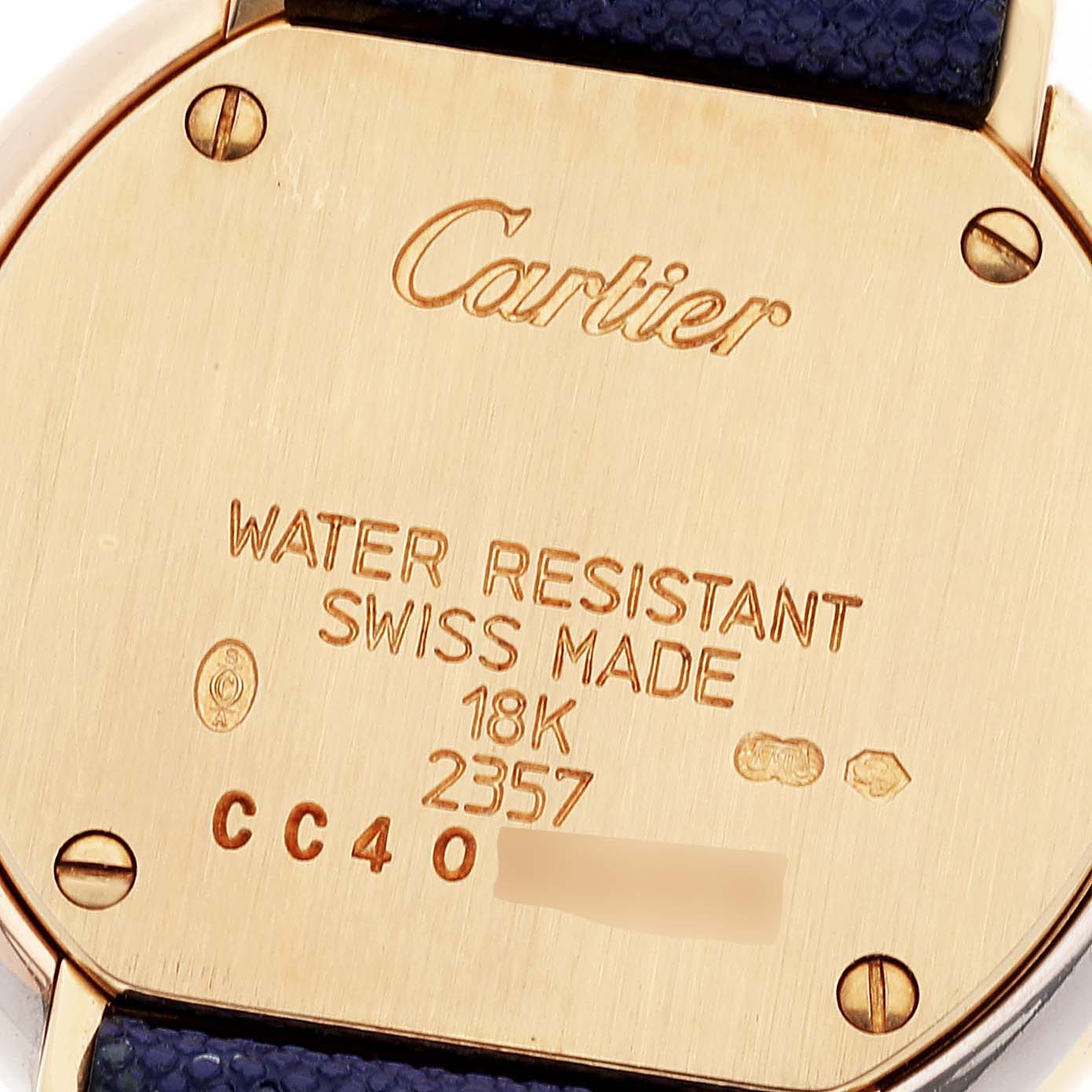 This image shows the back of a Cartier Trinity WG200256 Women
s Yellow Gold Silver Dial WG200256 Women
s Yellow Gold Silver Dial watch, highlighting its water resistance, "Swiss Made" marking, and 18K gold content.