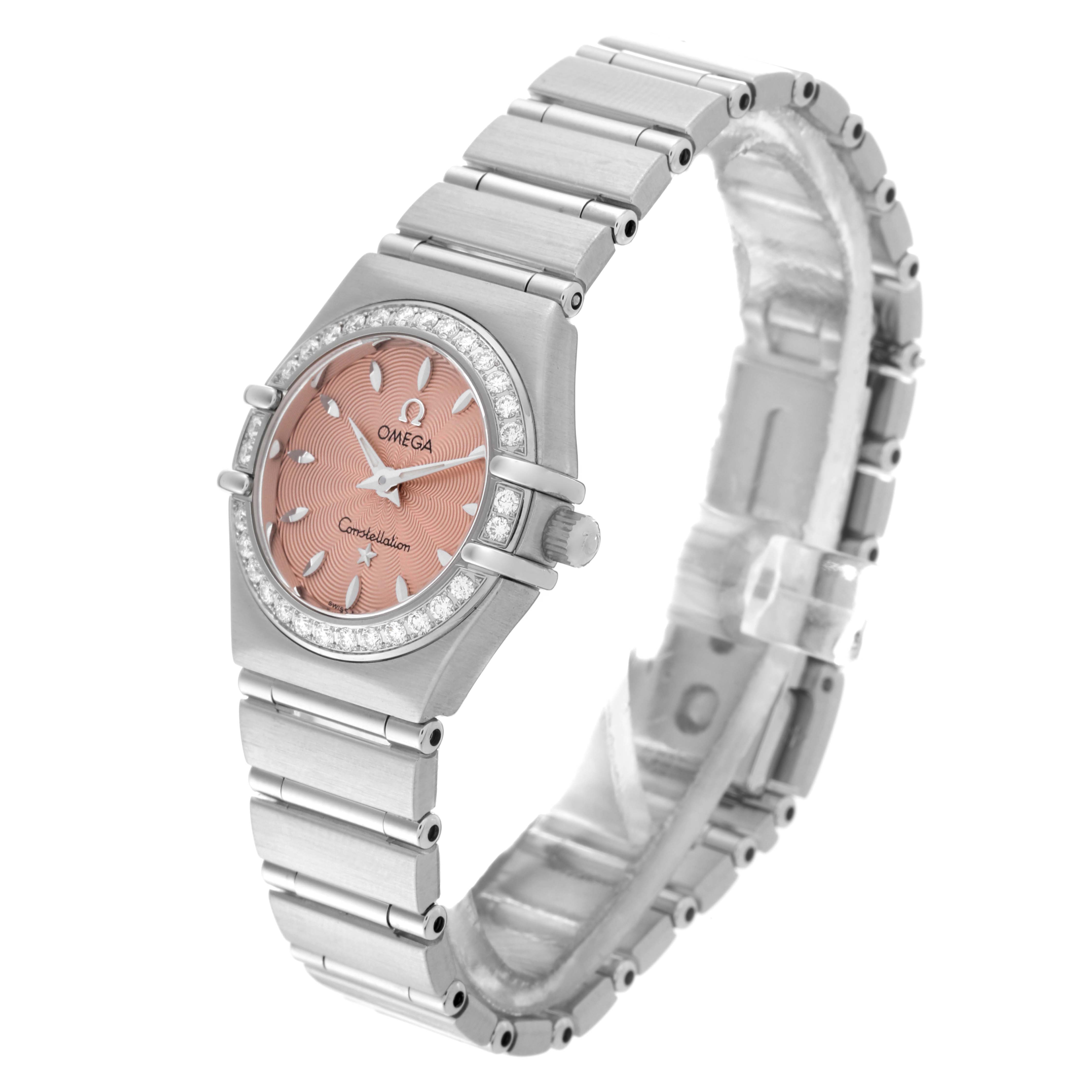 The Omega 1466.62.00 Women's Stainless Steel Pink Dial 1466.62.00 Women's Stainless Steel Pink Dial Constellation Mini 22mm 1466.62.00 watch is shown at an angled side view, displaying its salmon dial, bezel, and bracelet.