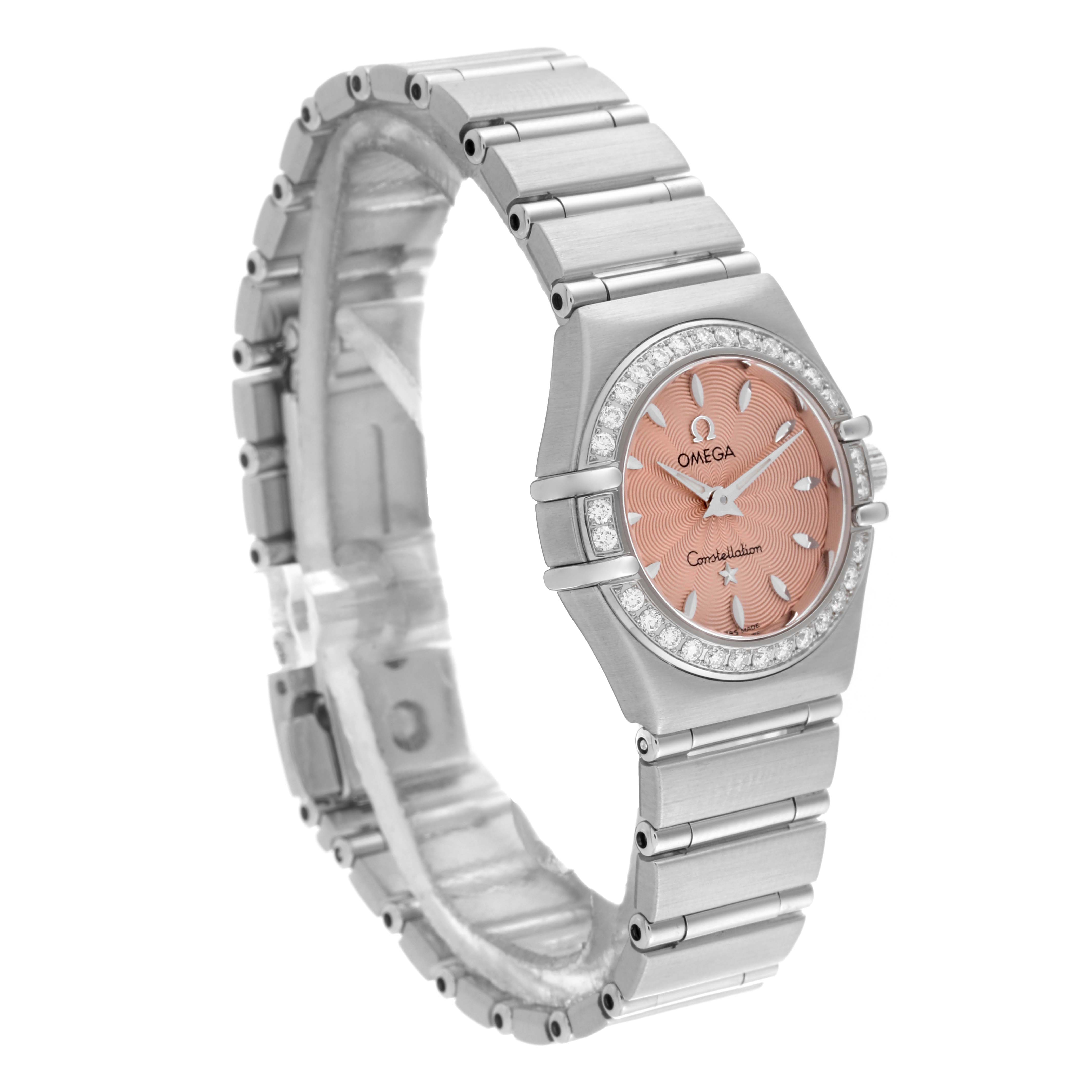 The Omega 1466.62.00 Women's Stainless Steel Pink Dial 1466.62.00 Women's Stainless Steel Pink Dial Constellation Mini 22mm 1466.62.00 is shown from a side angle, displaying the salmon dial, diamond bezel, and stainless steel bracelet.