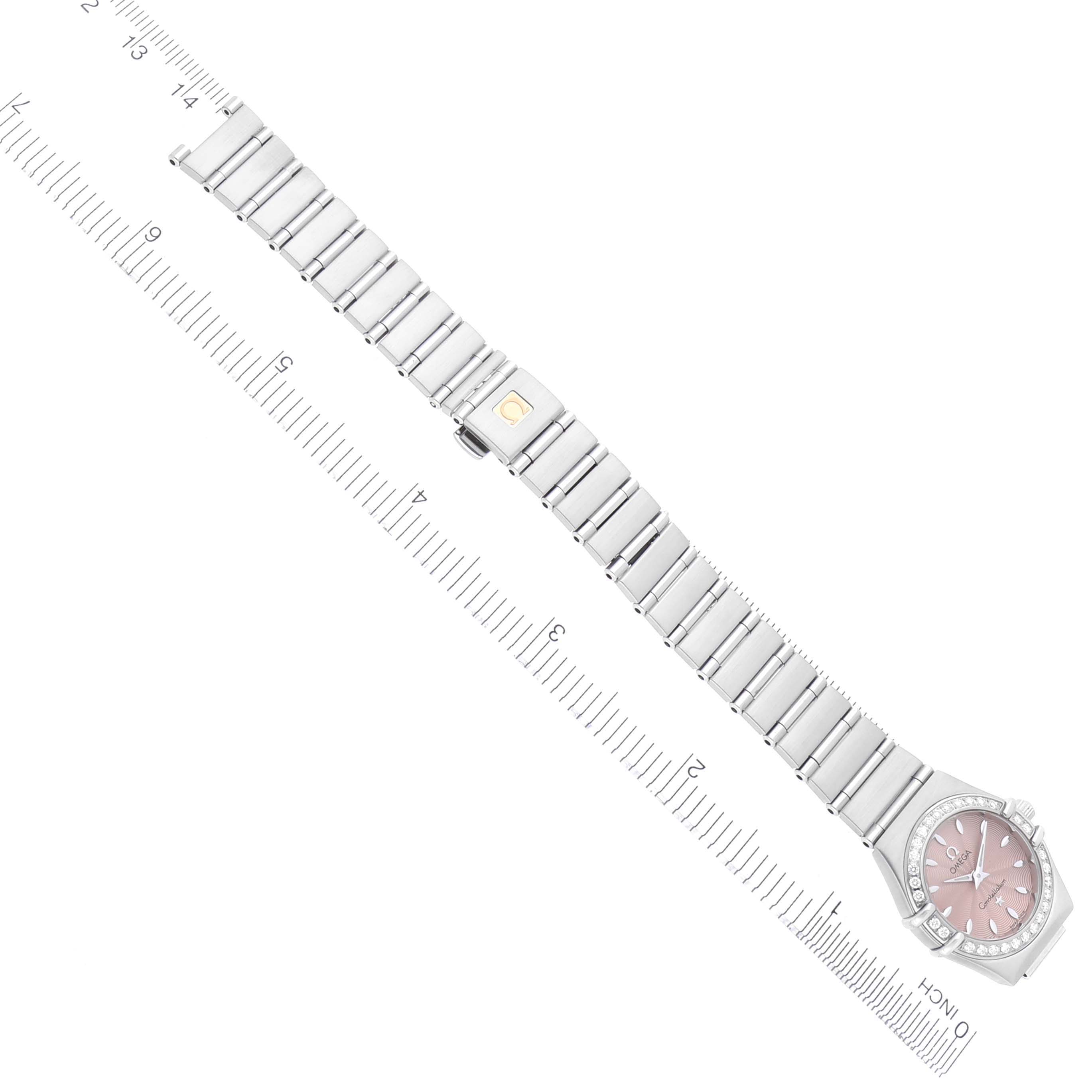 The Omega 1466.62.00 Women's Stainless Steel Pink Dial 1466.62.00 Women's Stainless Steel Pink Dial Constellation Mini 22mm Salmon Dial Ladies Watch 1466.62.00 is shown flat from above with its band extended next to a ruler.