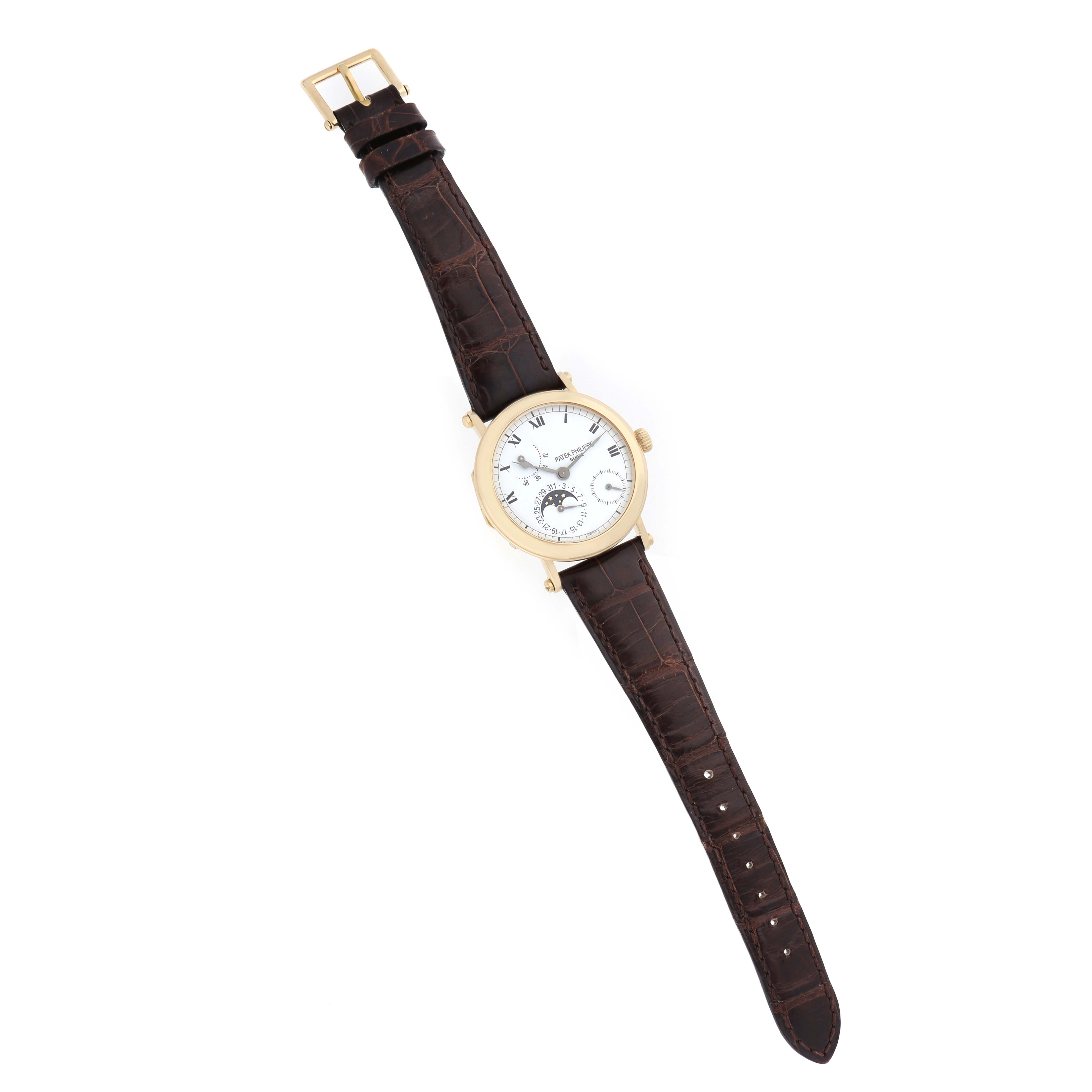 The Patek Philippe Complications 5054 Men
s Yellow Gold White Dial watch is shown in a top-down angle, displaying the face, bezel, and full brown leather strap.