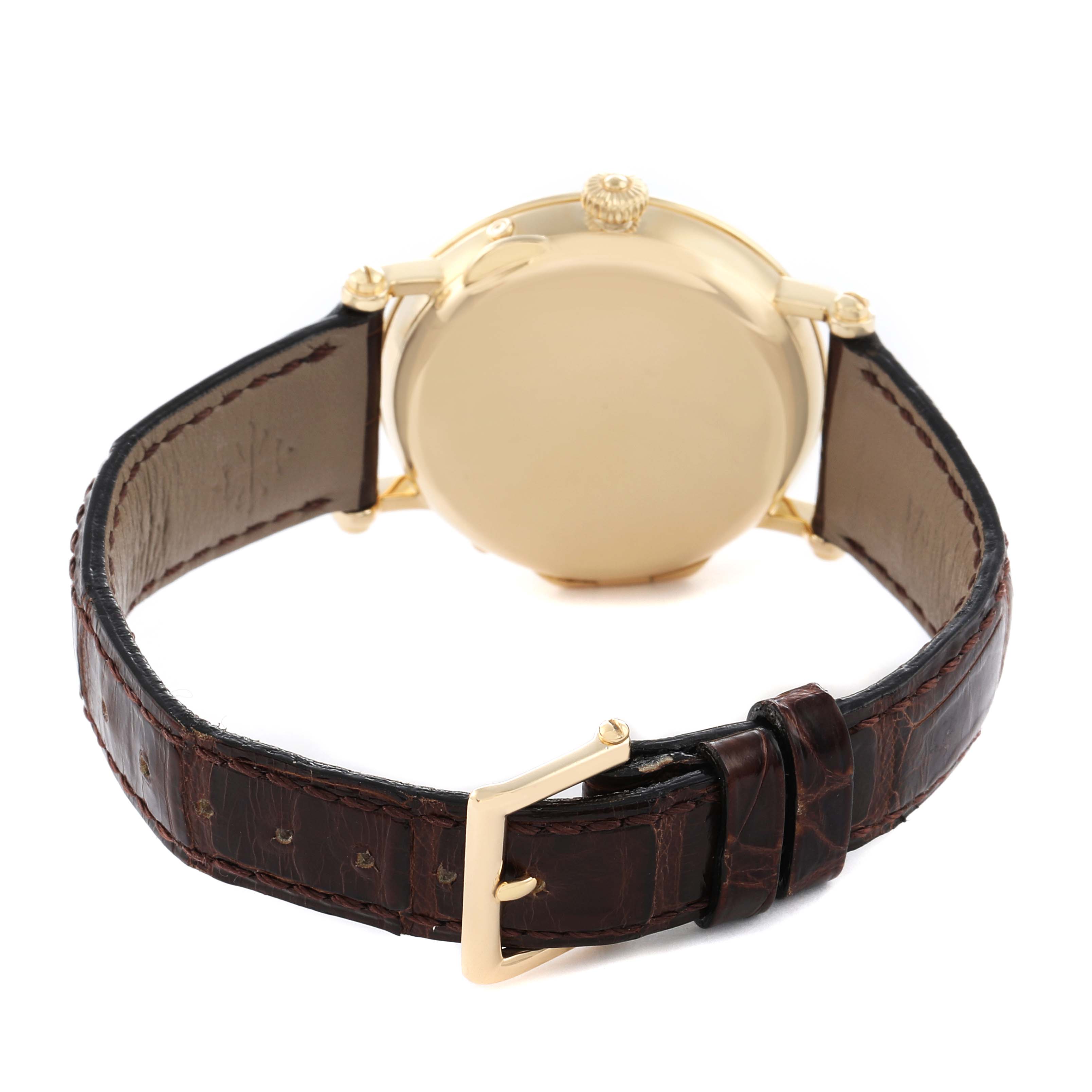 The image shows the back view of a Patek Philippe Complications 5054 Men
s Yellow Gold White Dial watch, highlighting the case back, crown, lugs, and strap buckle.