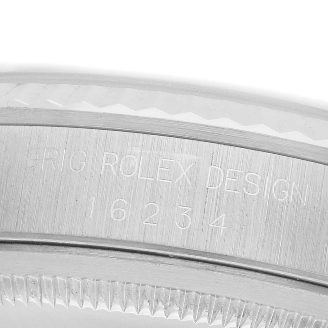 The image shows a close-up of the watch case side of a Rolex Datejust 16234 Men
s Stainless Steel Silver Dial, highlighting the engraving and bezel teeth.