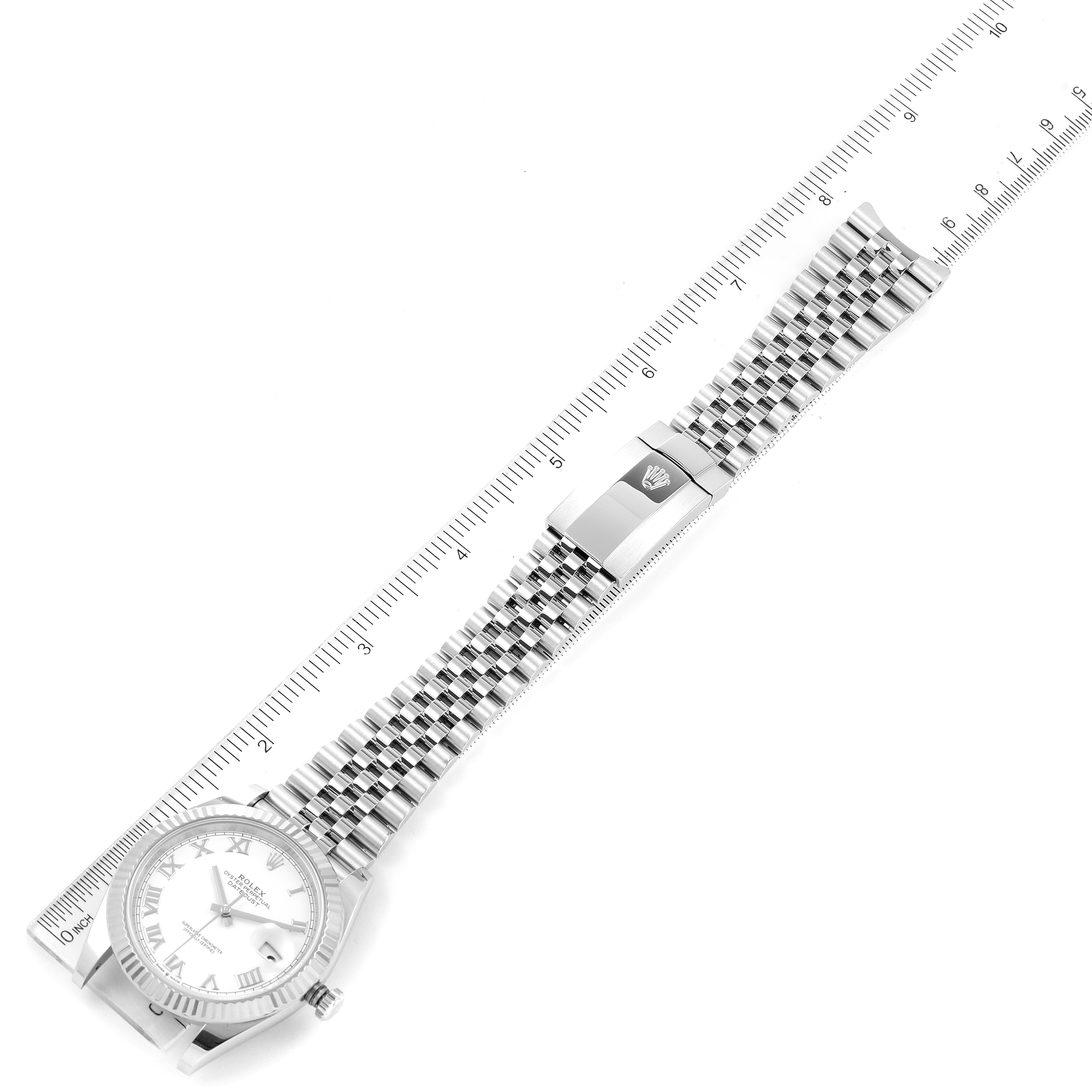 The image shows a Rolex Datejust 41 126334 Men
s Stainless Steel White Dial 126334 Men
s Stainless Steel White Dial watch laid flat with its dial, bracelet, and clasp visible along a measuring ruler.