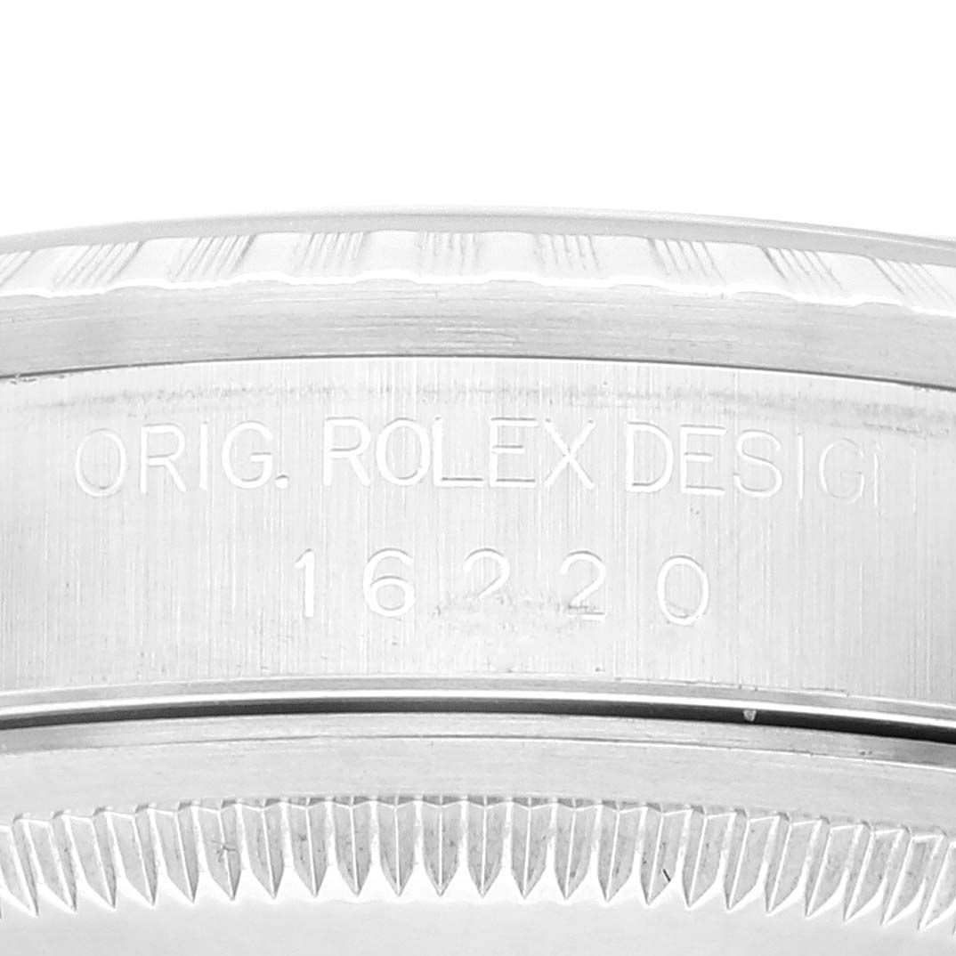 The image shows a close-up angle of the side of a Rolex Datejust 16220 Men's Stainless Steel Blue Dial 16220 Men's Stainless Steel Blue Dial watch, highlighting the engraving and part of the bezel.