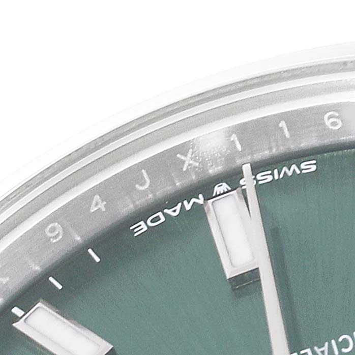 This close-up image of a Rolex Mid-Size 278240 Women's Stainless Steel Green Dial 278240 Women's Stainless Steel Green Dial model shows the top portion of the dial and the hour markers.