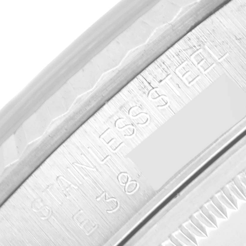 This close-up image shows part of the bezel and the inner ring with engravings on a Rolex Datejust 16234 Men's Stainless Steel Silver Dial 16234 Men's Stainless Steel Silver Dial watch.