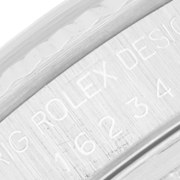 This close-up image features the engraved watch case side of a Rolex Datejust 16234 Men's Stainless Steel Silver Dial 16234 Men's Stainless Steel Silver Dial model.