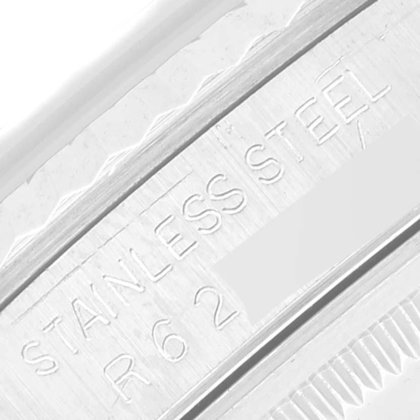 The image shows an extreme close-up of the stainless steel engraving inside the bezel of a Rolex Datejust 16234 Men's Stainless Steel Silver Dial 16234 Men's Stainless Steel Silver Dial watch.