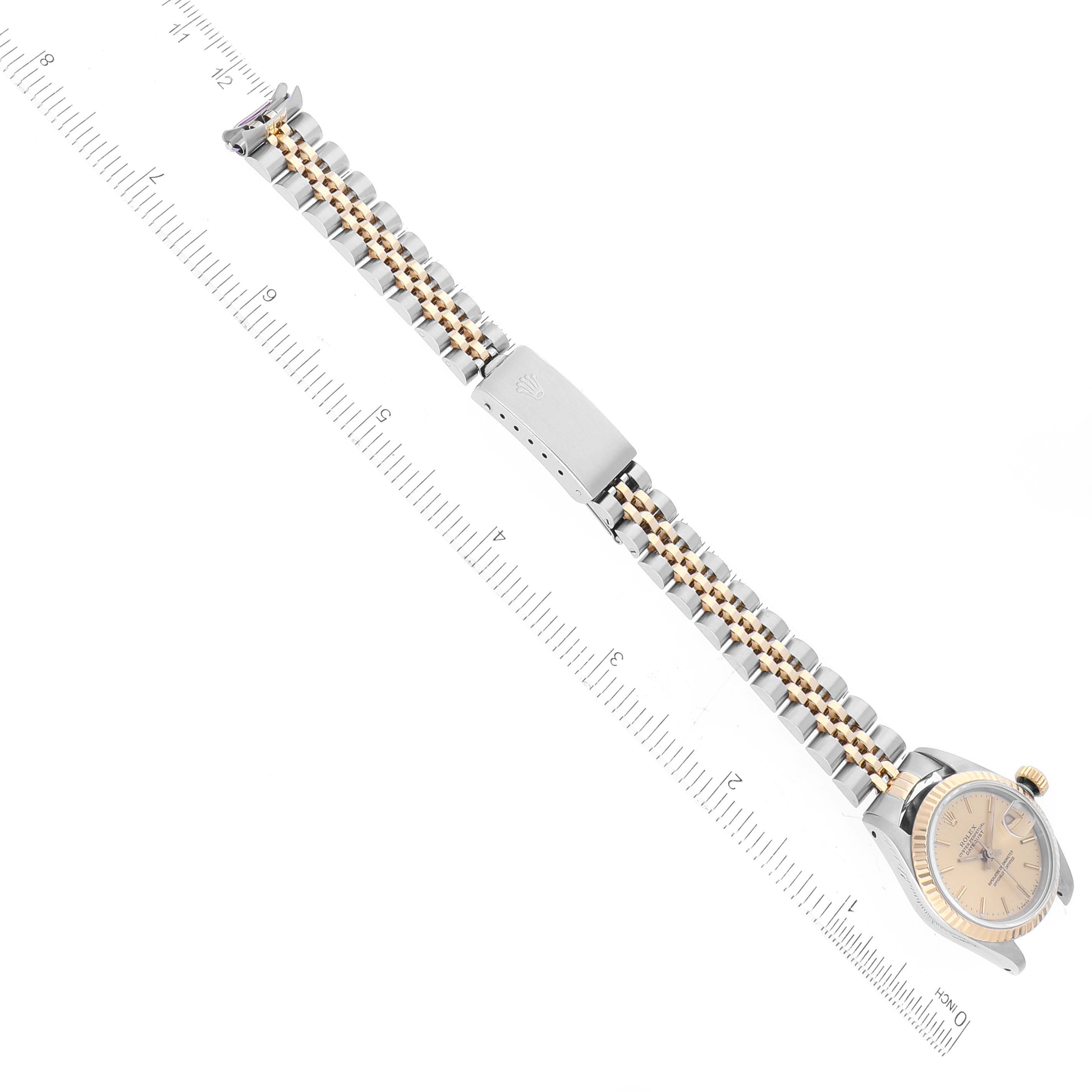 The image shows a Rolex Datejust 69173 Women's Steel and Gold (two tone) Champagne Dial 69173 Women's Steel and Gold (two tone) Champagne Dial watch laid flat, displaying the face, bracelet, and clasp, aligned with a ruler for scale.