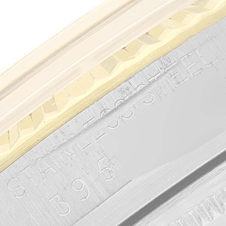 This image shows a close-up of the bezel and part of the casing with "STAINLESS STEEL" text on a Vintage Collection Rolex watch.