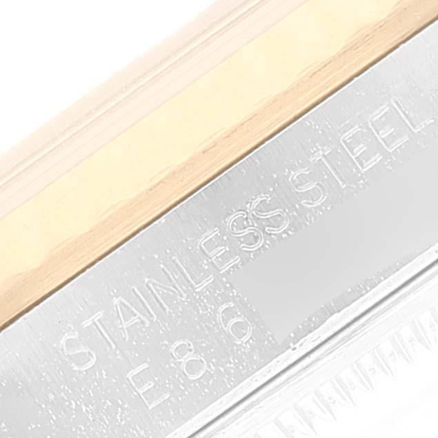 This close-up shows the Rolex Datejust 16233 Men's Steel and Gold (two tone) Beige Dial 16233 Men's Steel and Gold (two tone) Beige Dial watch case, highlighting the "STAINLESS STEEL" engraving.