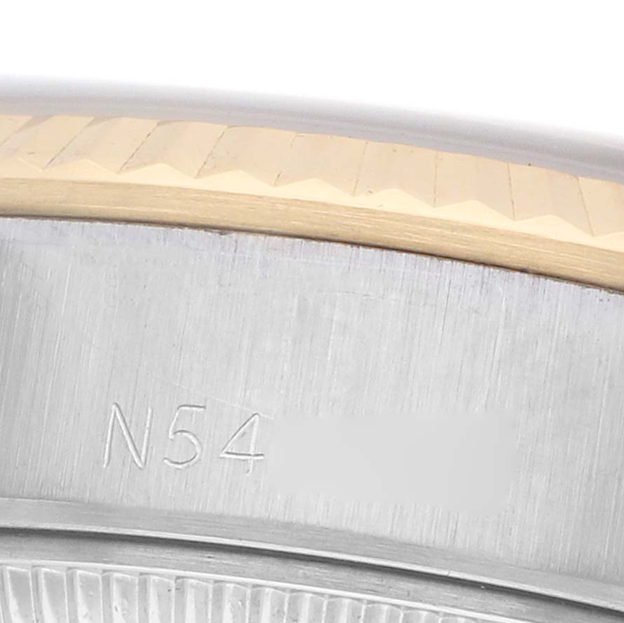 The image shows a close-up of the Rolex Datejust 69173 Women
s Steel and Gold (two tone) Silver Dial bezel and engraving on the side of the case.