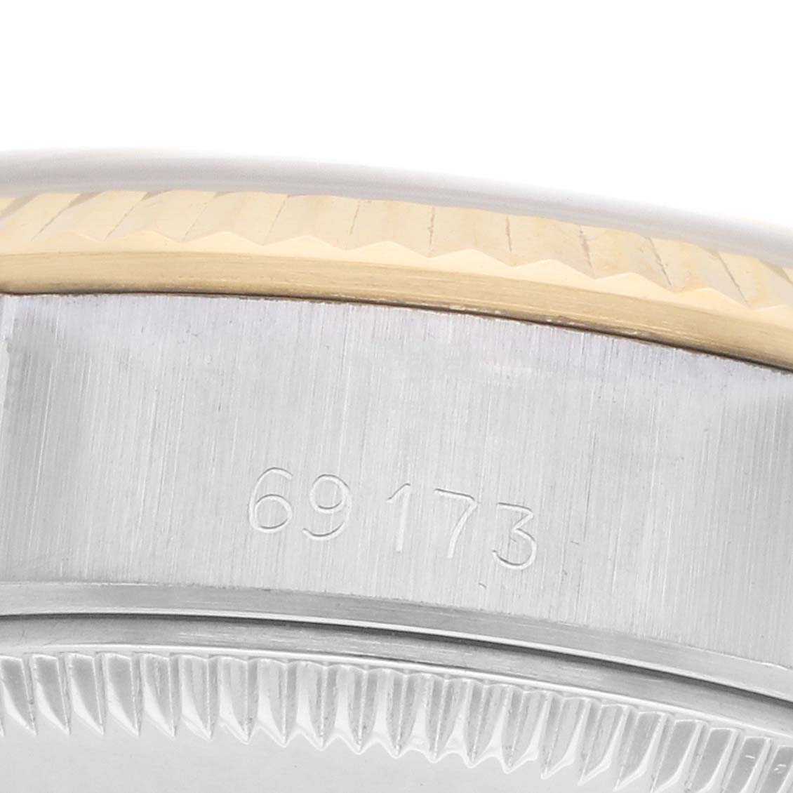 The image shows a close-up side angle of a Rolex Datejust 69173 Women
s Steel and Gold (two tone) Silver Dial model, focusing on the bezel and case details with a visible model number.