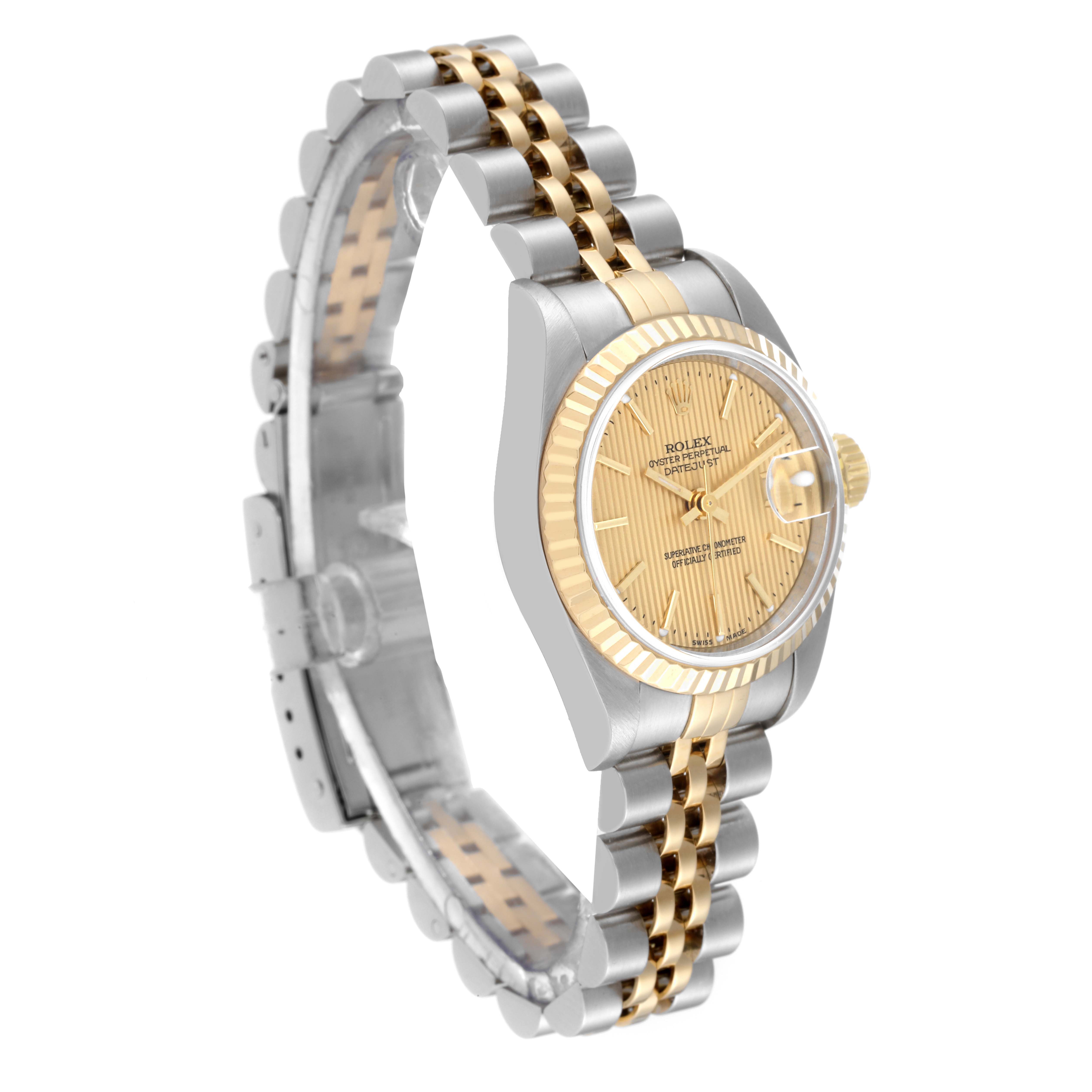 The Rolex Datejust 79173 Women's Steel and Gold (two tone) Champagne Dial 79173 Women's Steel and Gold (two tone) Champagne Dial watch is shown at a three-quarter angle, highlighting its two-tone bracelet, fluted bezel, and face.