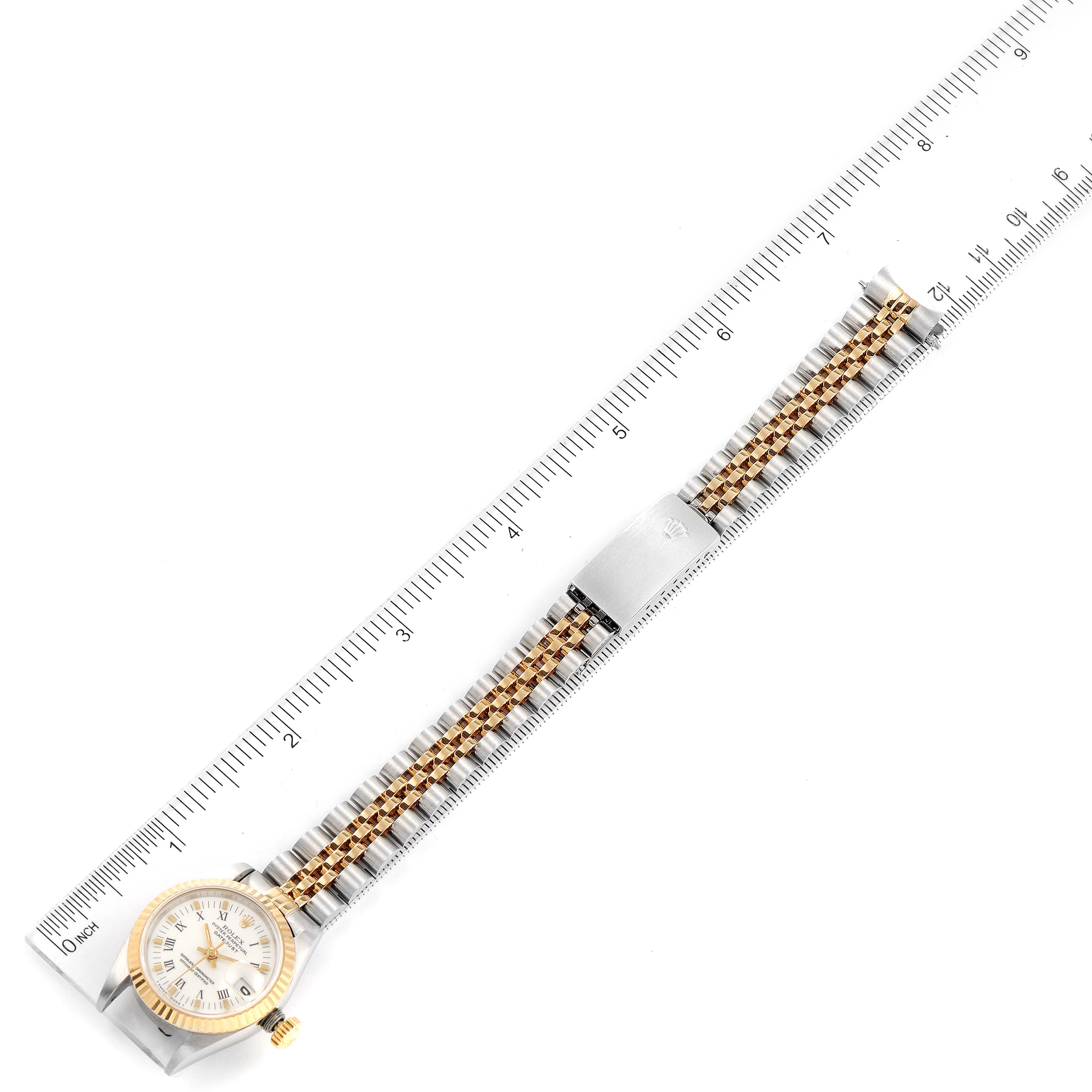 The image shows a Rolex Datejust 69173 Women's Steel and Gold (two tone) White Dial 69173 Women's Steel and Gold (two tone) White Dial watch from a top-down angle, displaying its face, bracelet, and clasp along with a ruler.