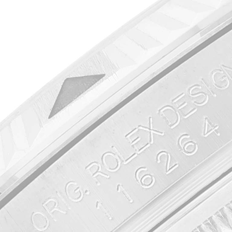 This image shows a close-up of the bezel and engraved serial number of a Rolex Turn-o-Graph 116264 Men's Stainless Steel Blue Dial 116264 Men's Stainless Steel Blue Dial watch.