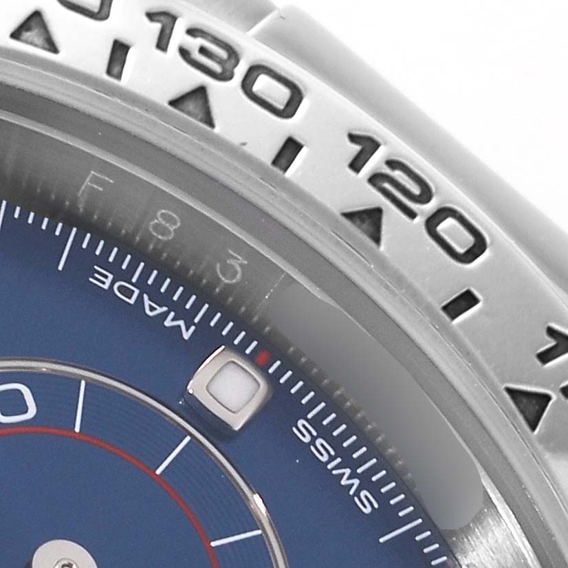 A close-up of a Rolex Daytona 116509 Men's White Gold Blue Dial 116509 Men's White Gold Blue Dial watch, showing part of the bezel, dial, and hour markers.