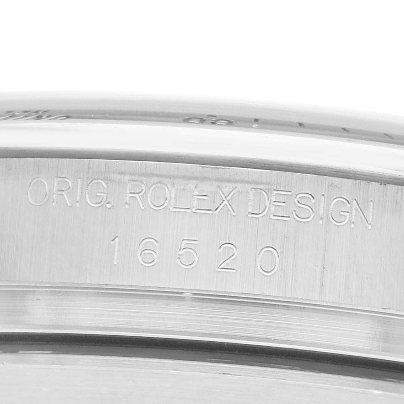 The image shows a close-up of the Rolex Daytona 16520 Men
s Stainless Steel Black Dial model 16520 case side with engraved design details.