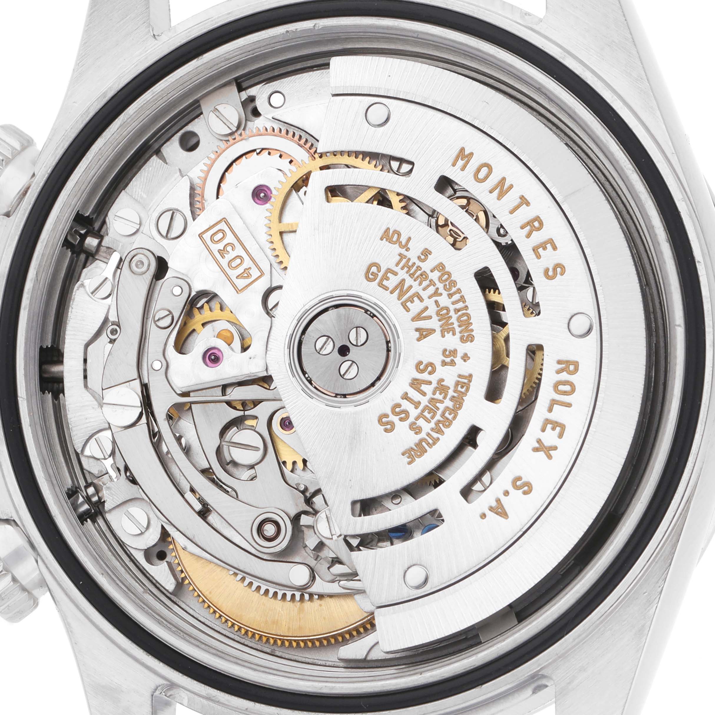 The image shows the intricate movement of a Rolex Daytona 16520 Men
s Stainless Steel Black Dial watch, viewed from the back, highlighting its gears and rotor.