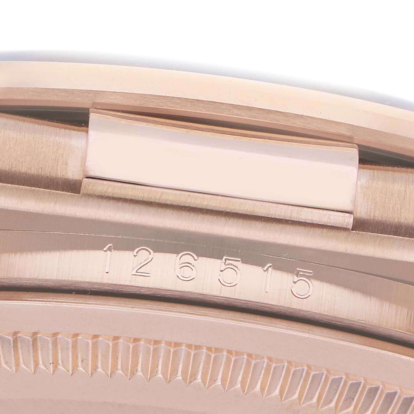 This image shows a close-up of the case side and serial number area of a Rolex Daytona 126515 Men
s Rose Gold Black Dial watch.