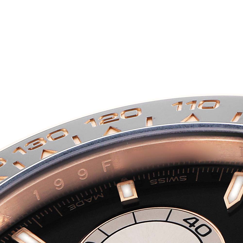 The image shows a partial close-up of the bezel and dial edge of a Rolex Daytona 126515 Men
s Rose Gold Black Dial watch, highlighting the tachymetric scale.