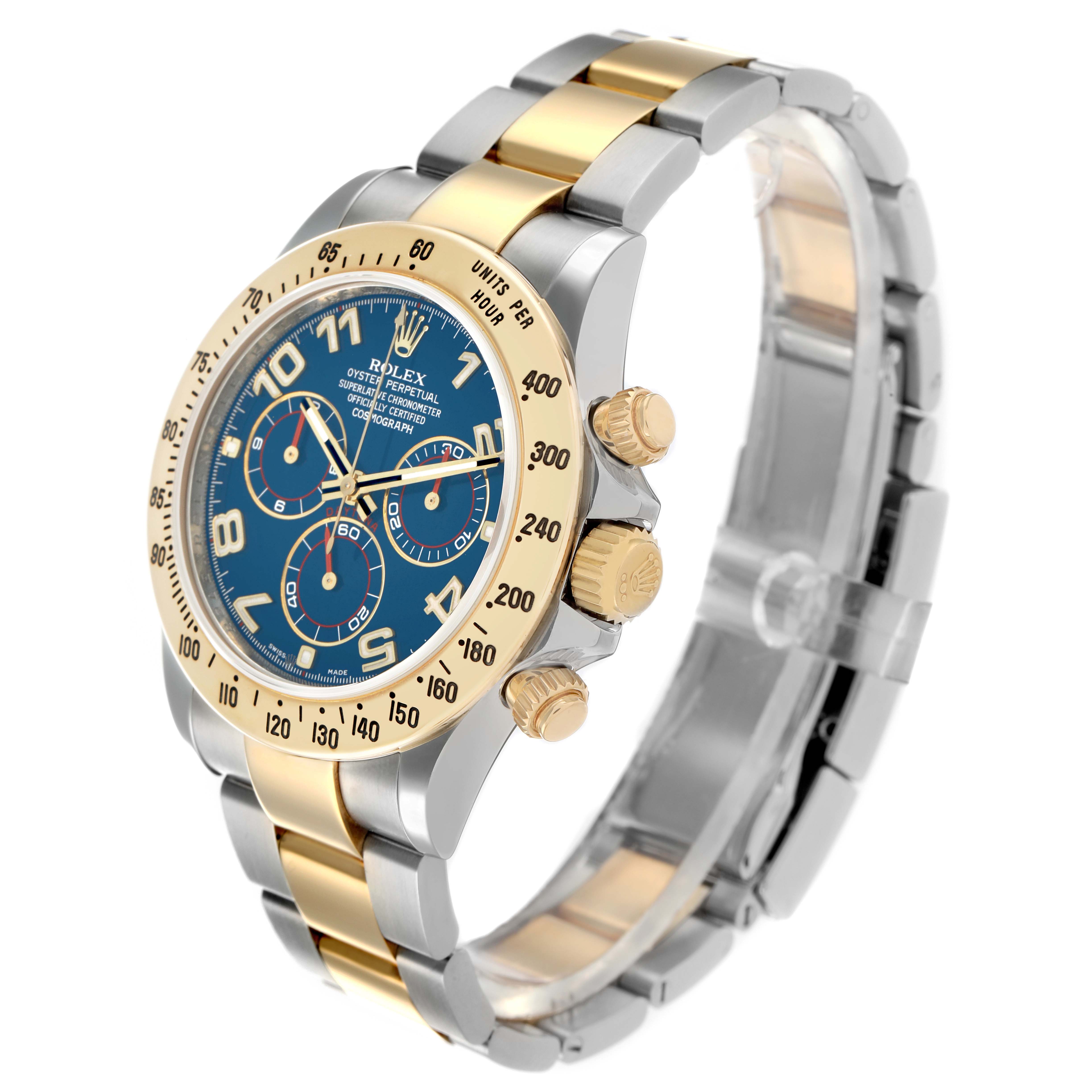The Rolex Daytona 116523 Men
s Steel and Gold (two tone) Blue Dial watch is shown at a three-quarter angle, displaying the face, bezel, crown, and bracelet.