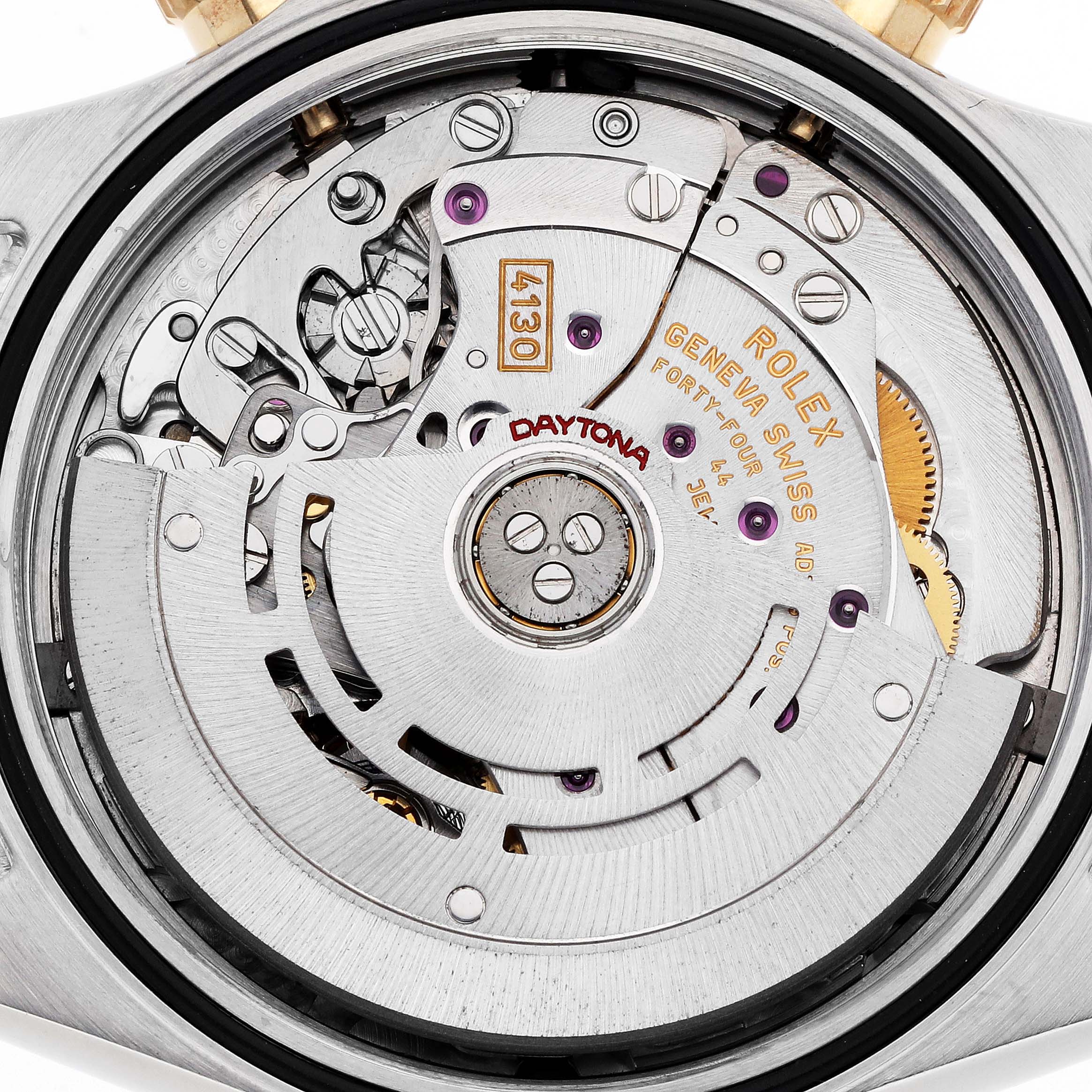 The image shows a close-up of the Rolex Daytona 116523 Men
s Steel and Gold (two tone) Blue Dial watch movement, highlighting the mechanism and engravings.