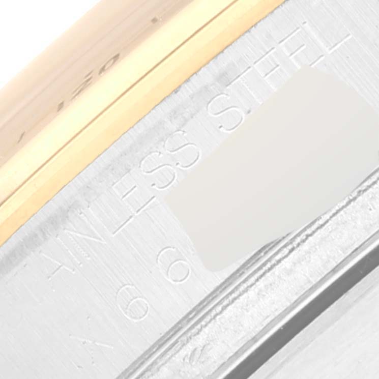 This close-up image features the stainless steel and gold bezel of a Rolex Daytona 16523 Men's Steel and Gold (two tone) White Dial 16523 Men's Steel and Gold (two tone) White Dial watch.