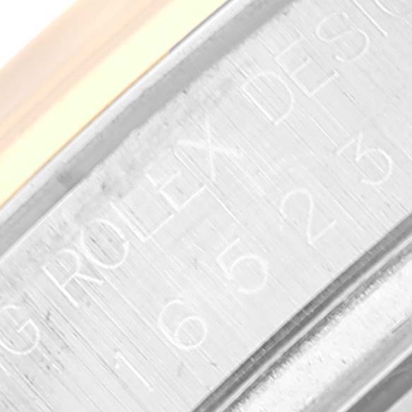This image shows a close-up of the engraved serial number area on the case of a Rolex Daytona 16523 Men's Steel and Gold (two tone) White Dial 16523 Men's Steel and Gold (two tone) White Dial watch.
