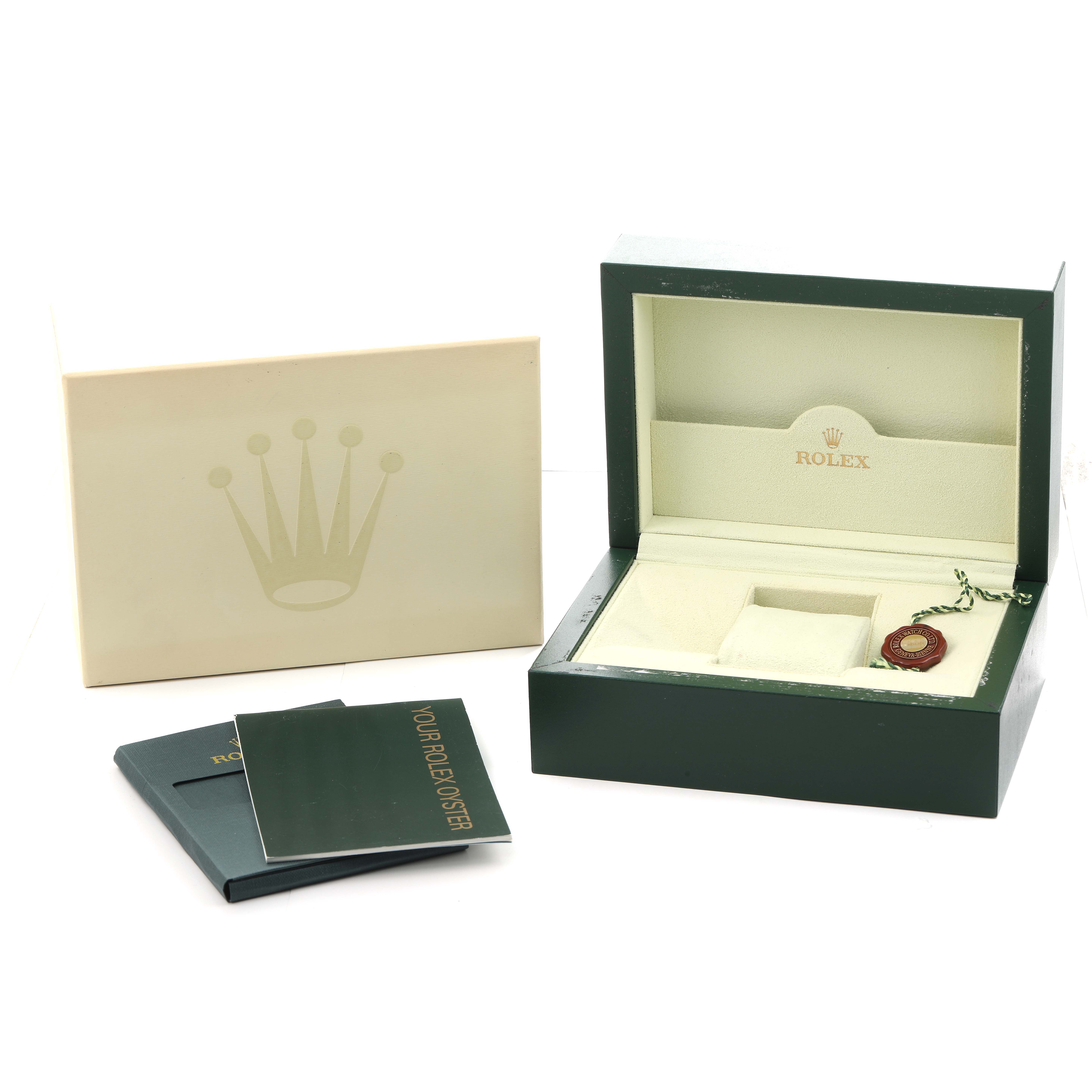 The image shows a Rolex Daytona 116518 Men
s Yellow Gold Black Dial box set with packaging, a booklet, and a tag, viewed from above.