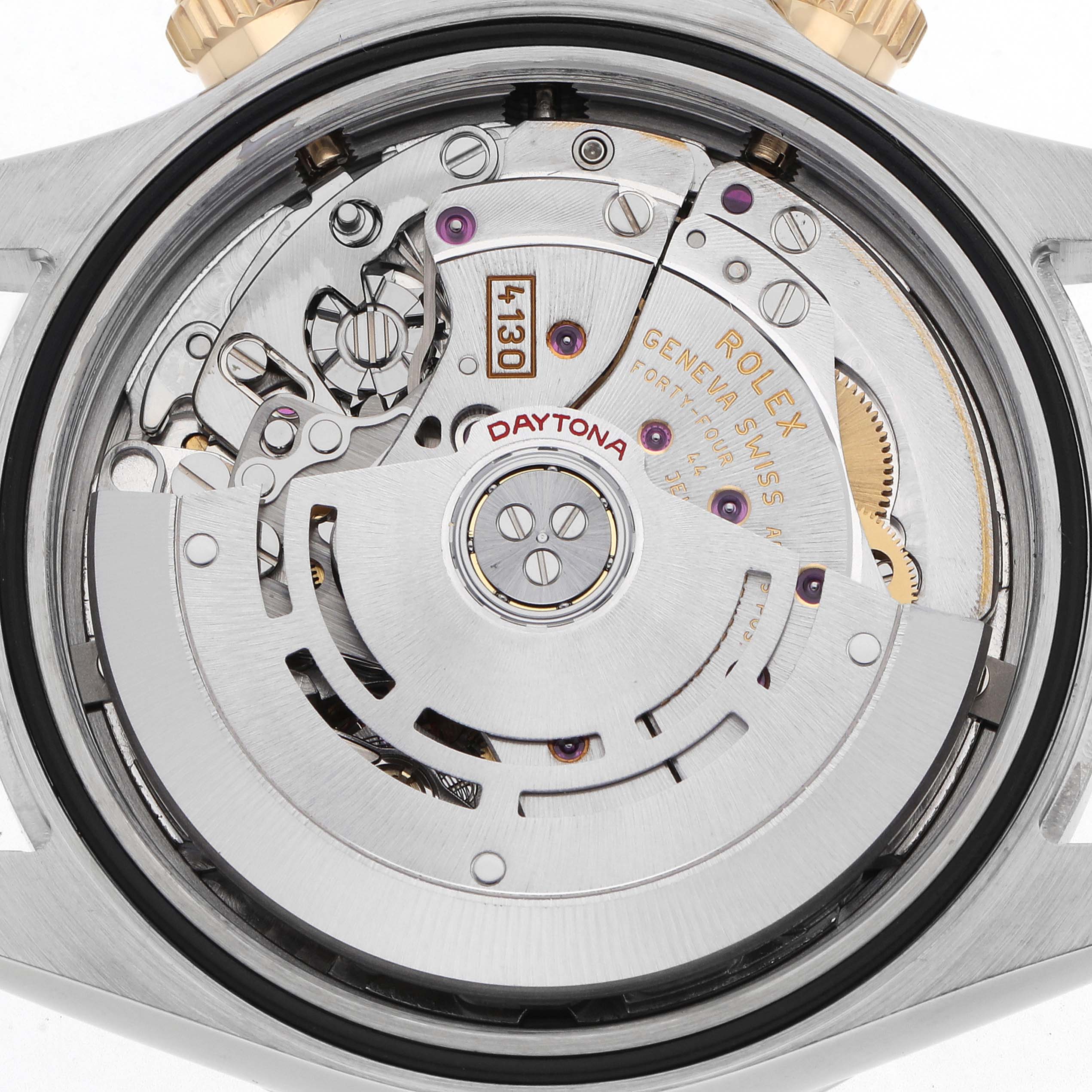 The image shows the back view of a Rolex Daytona 116523 Men
s Steel and Gold (two tone) White Dial, focusing on its mechanical movement and rotor.