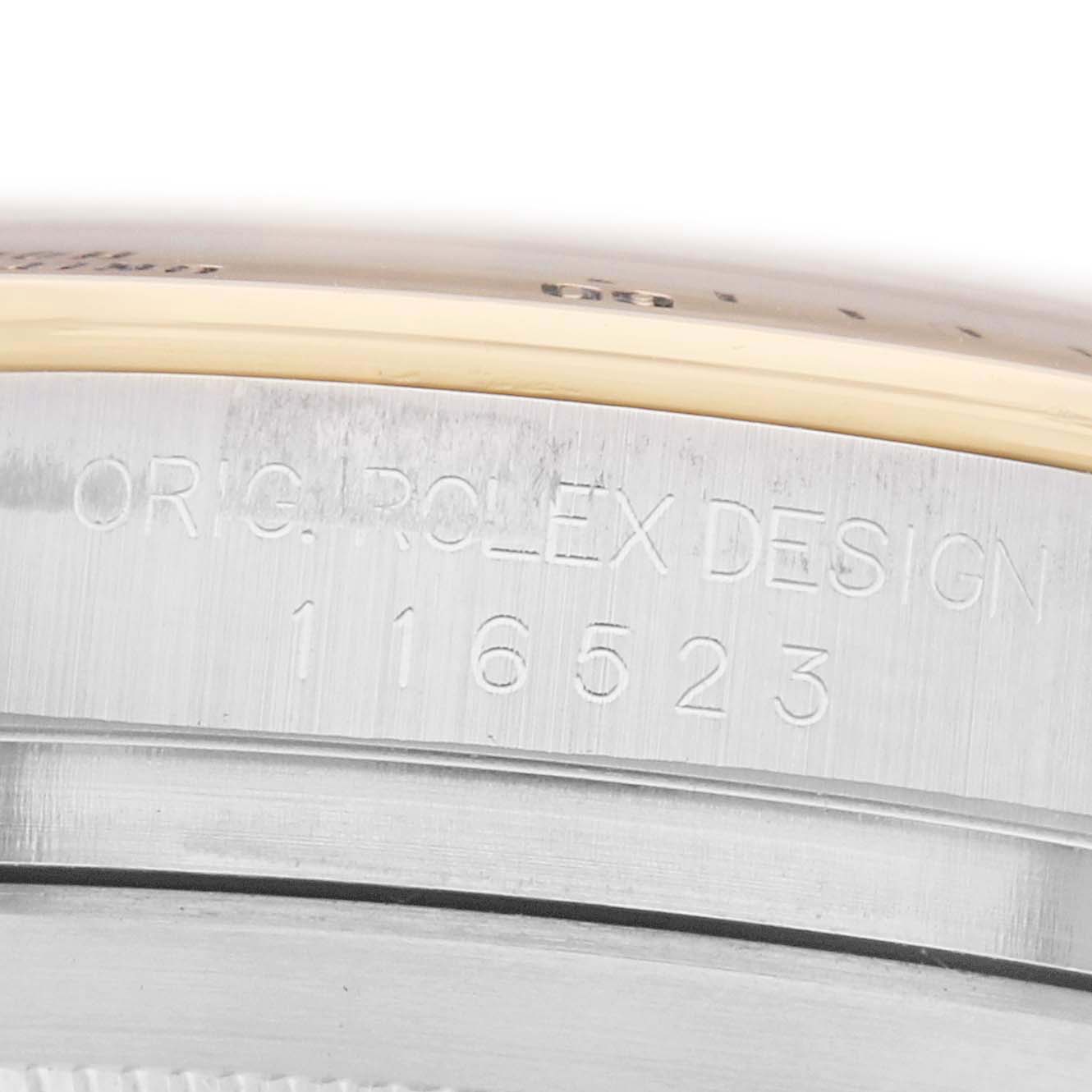 The image shows a close-up of the Daytona model by Rolex, focusing on the engraved serial number on the case.