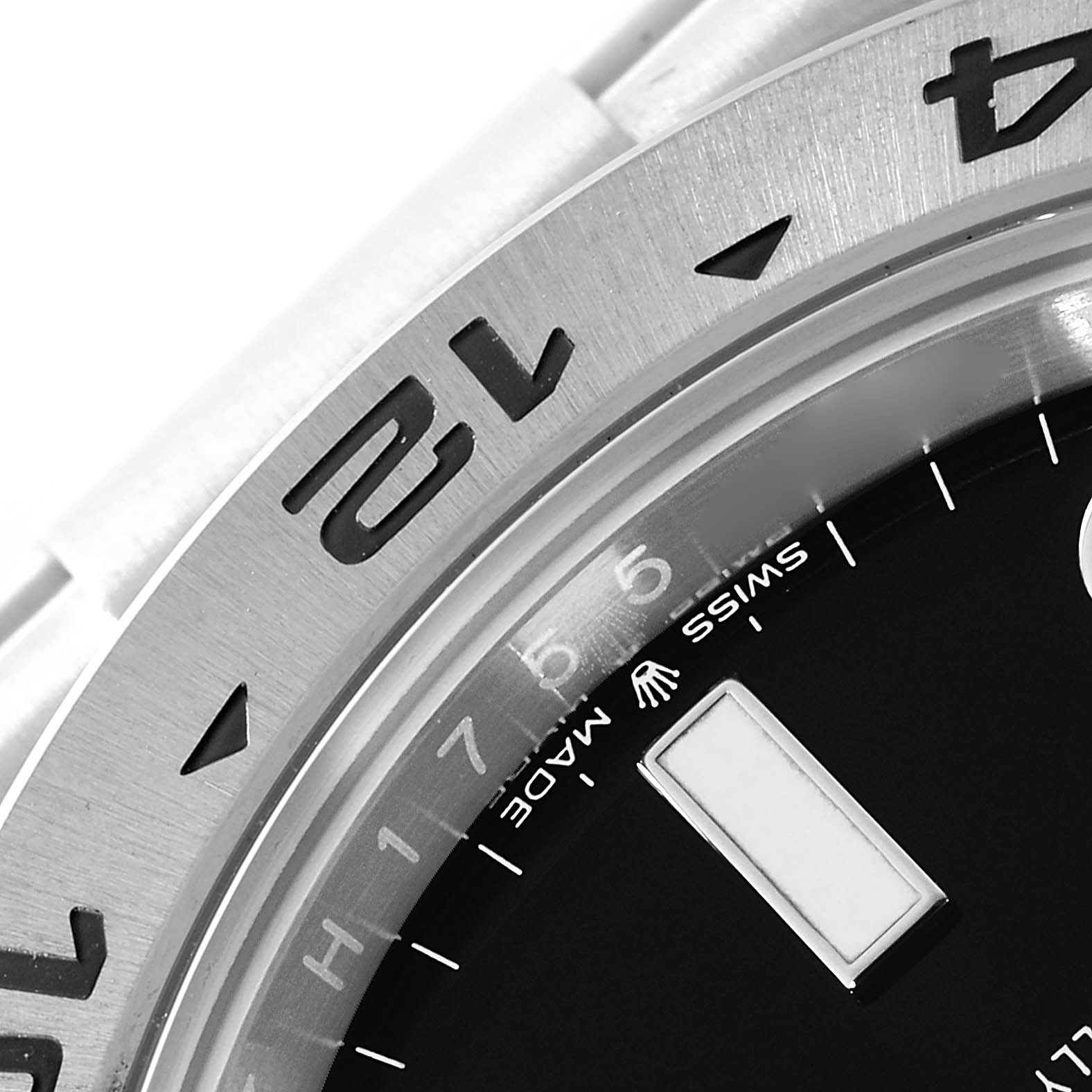 The image shows a close-up of the bezel and part of the dial of a Rolex Explorer 226570 Men
s Stainless Steel Black Dial 226570 Men
s Stainless Steel Black Dial watch.