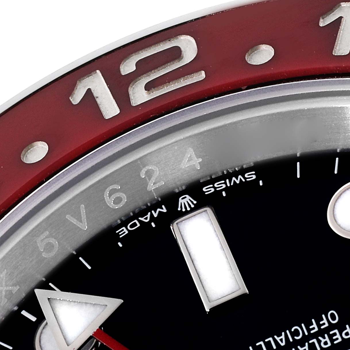 This is a close-up of the bezel and dial of a Rolex GMT-Master 126710 Men's Stainless Steel Black Dial 126710 Men's Stainless Steel Black Dial watch, focusing on the 12 o'clock mark.