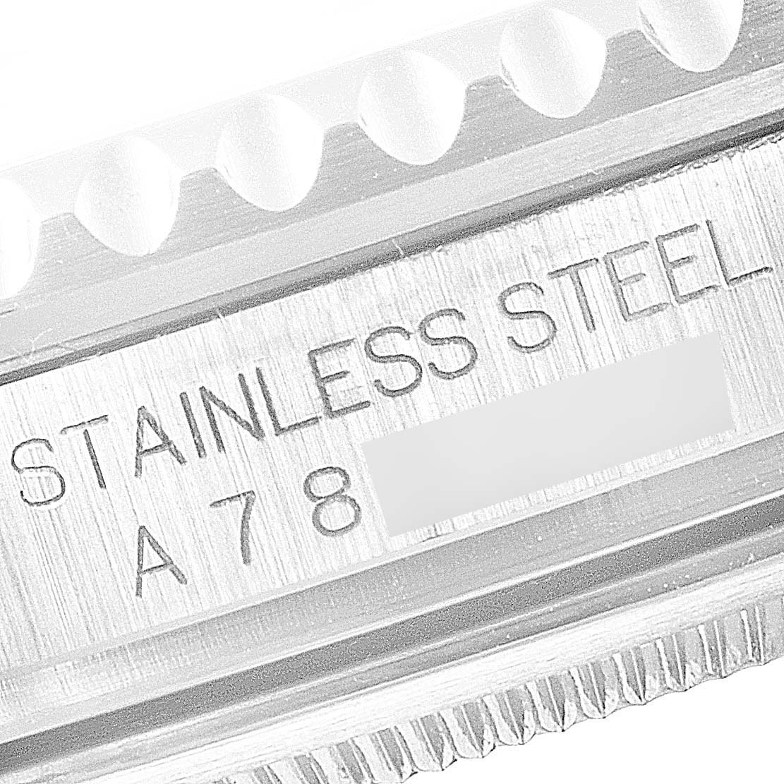 The image shows a close-up of the case side of a Rolex GMT-Master 16710 Men
s Stainless Steel Black Dial 16710 Men
s Stainless Steel Black Dial, highlighting "STAINLESS STEEL" and part of the serial number.