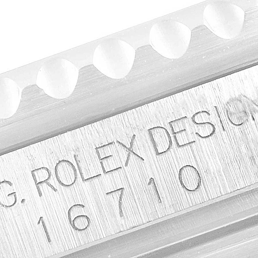 This close-up image shows the serial number and model engraving on the side of the Rolex GMT-Master 16710 Men
s Stainless Steel Black Dial 16710 Men
s Stainless Steel Black Dial 16710 watch case.